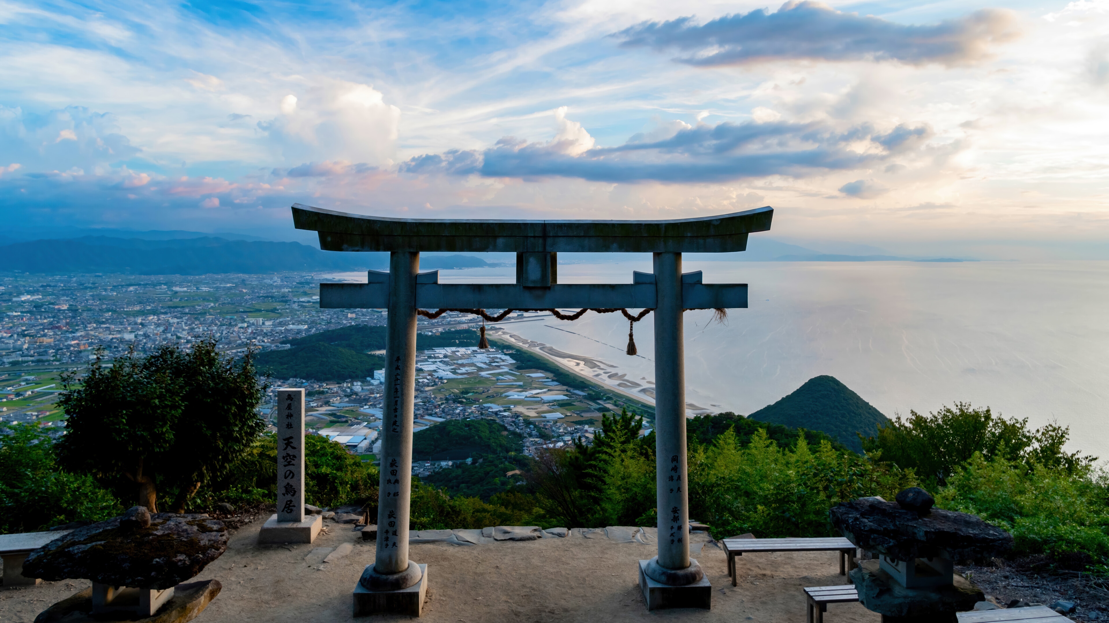Torii Gate Overlooking a Coastal City and Ocean HD Wallpaper