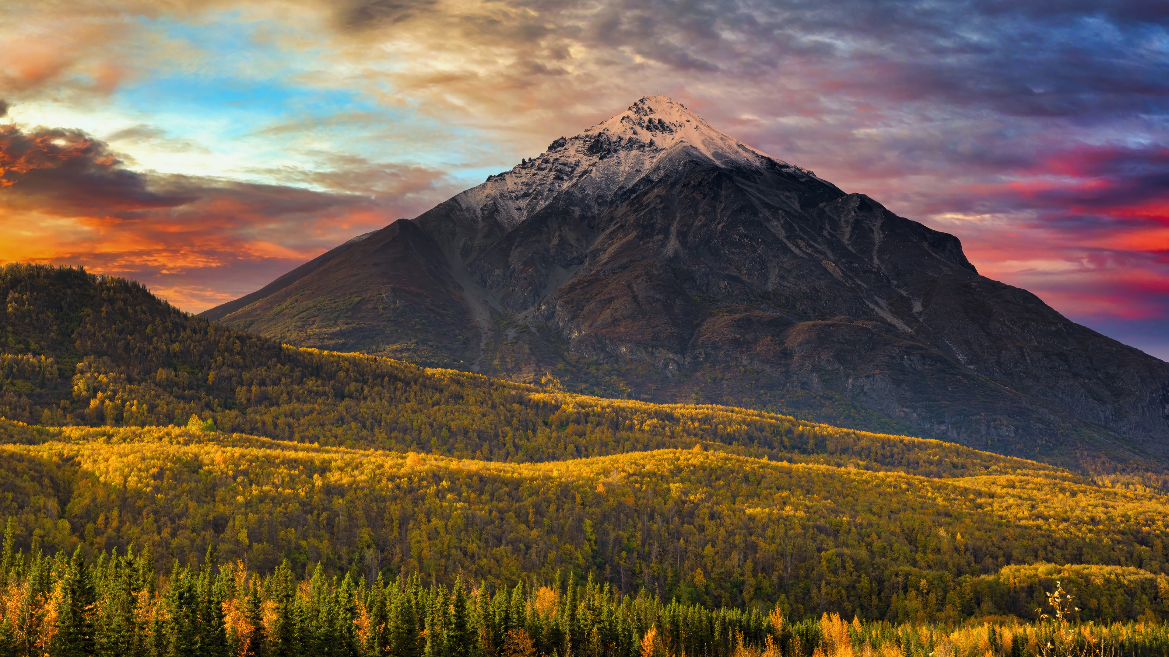 Mountain peak with autumn forest and dramatic sky HD Wallpaper