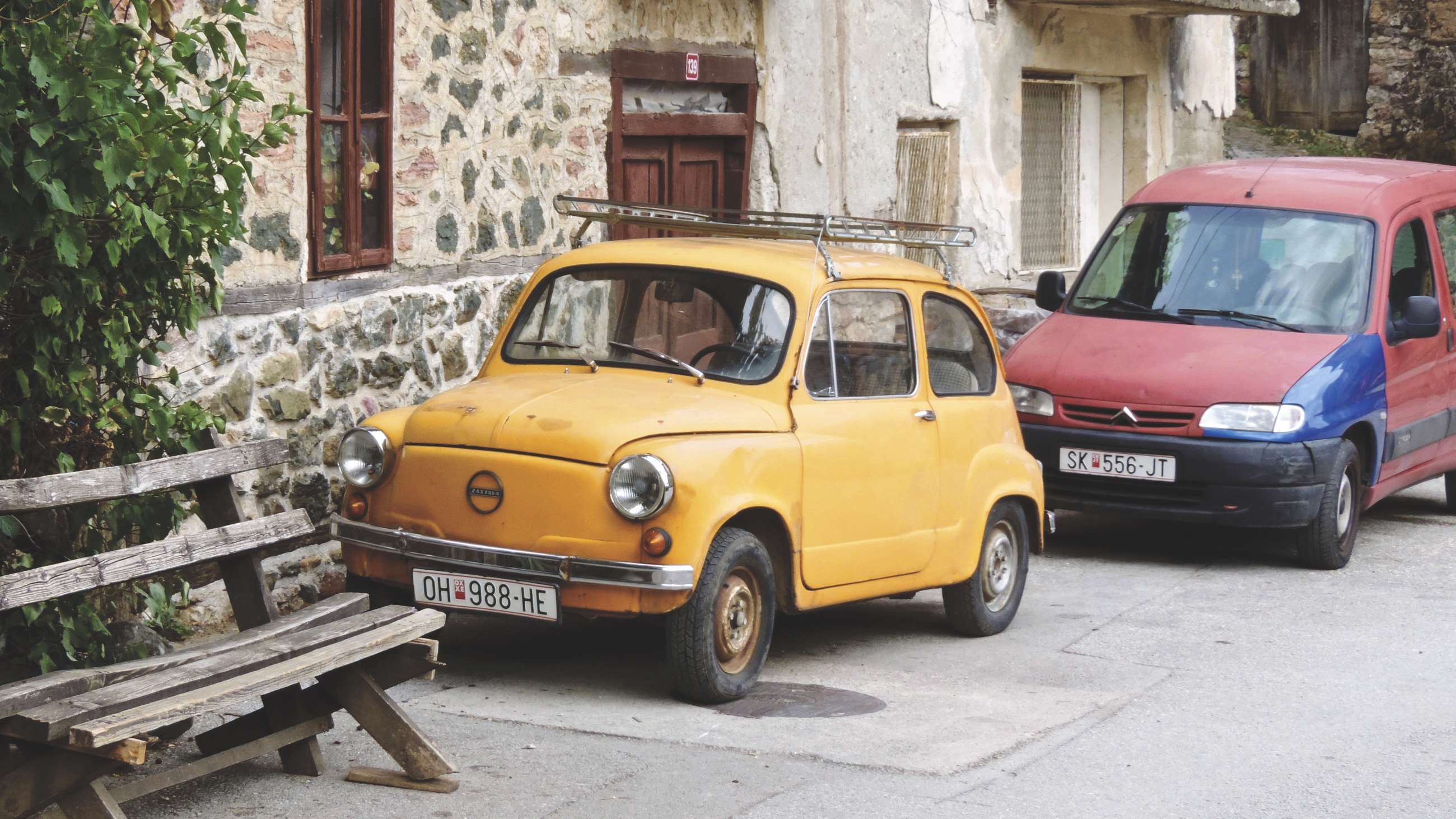 Yellow Fiat 600 and red-blue van parked HD Wallpaper