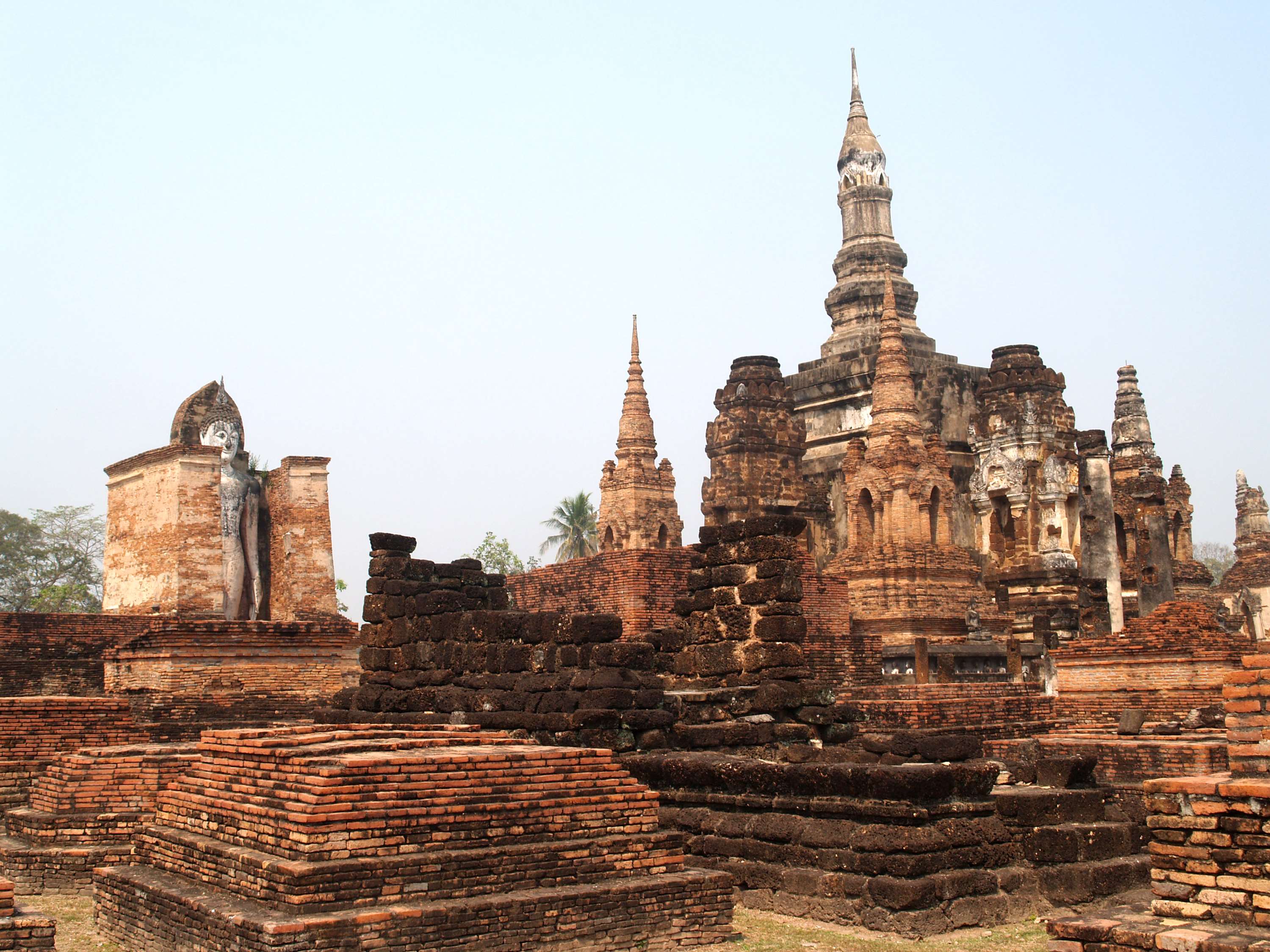 Ancient Buddhist temple ruins with Buddha statue HD Wallpaper