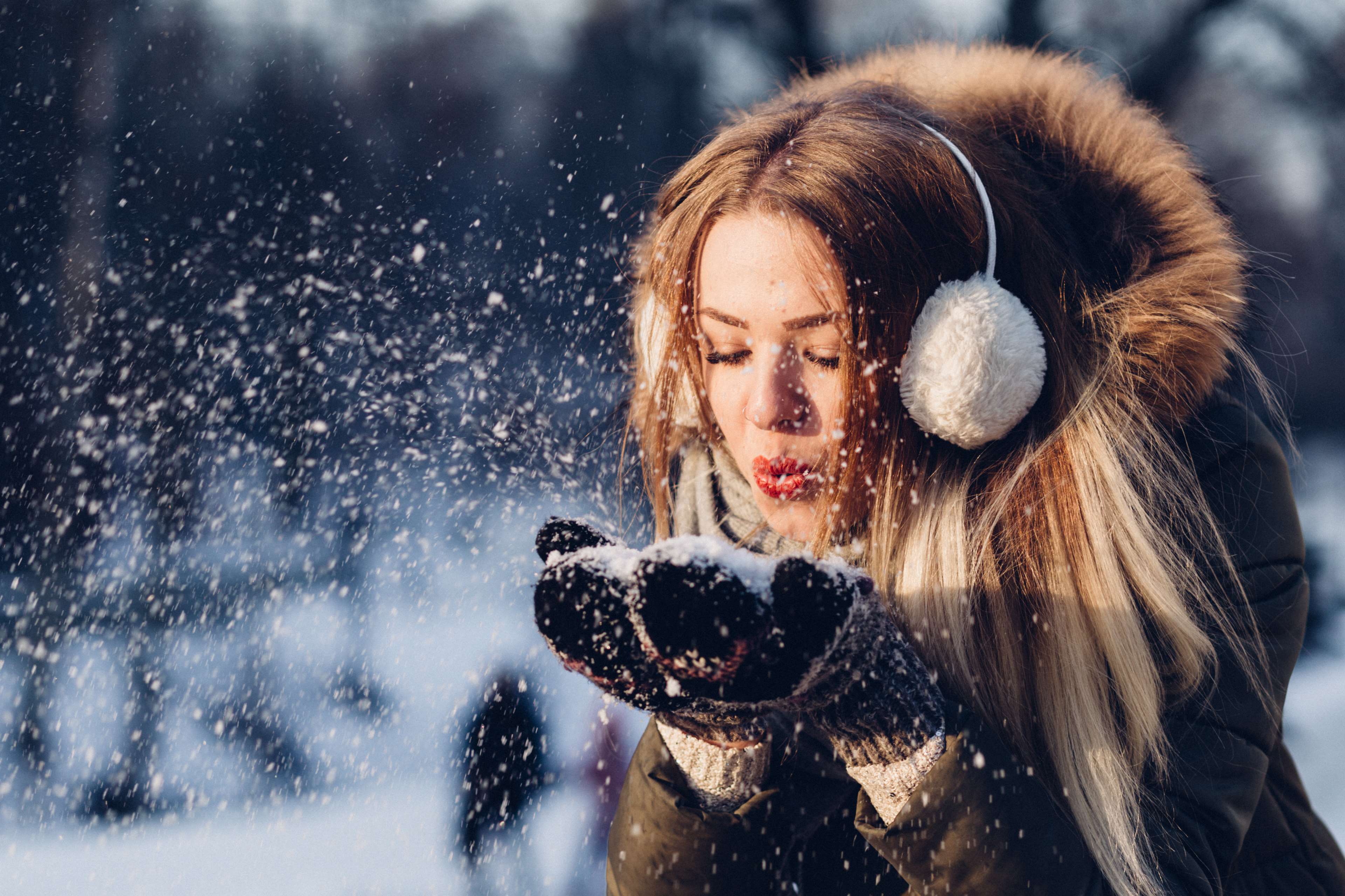 Young woman blowing snow in winter 4K HD Wallpaper