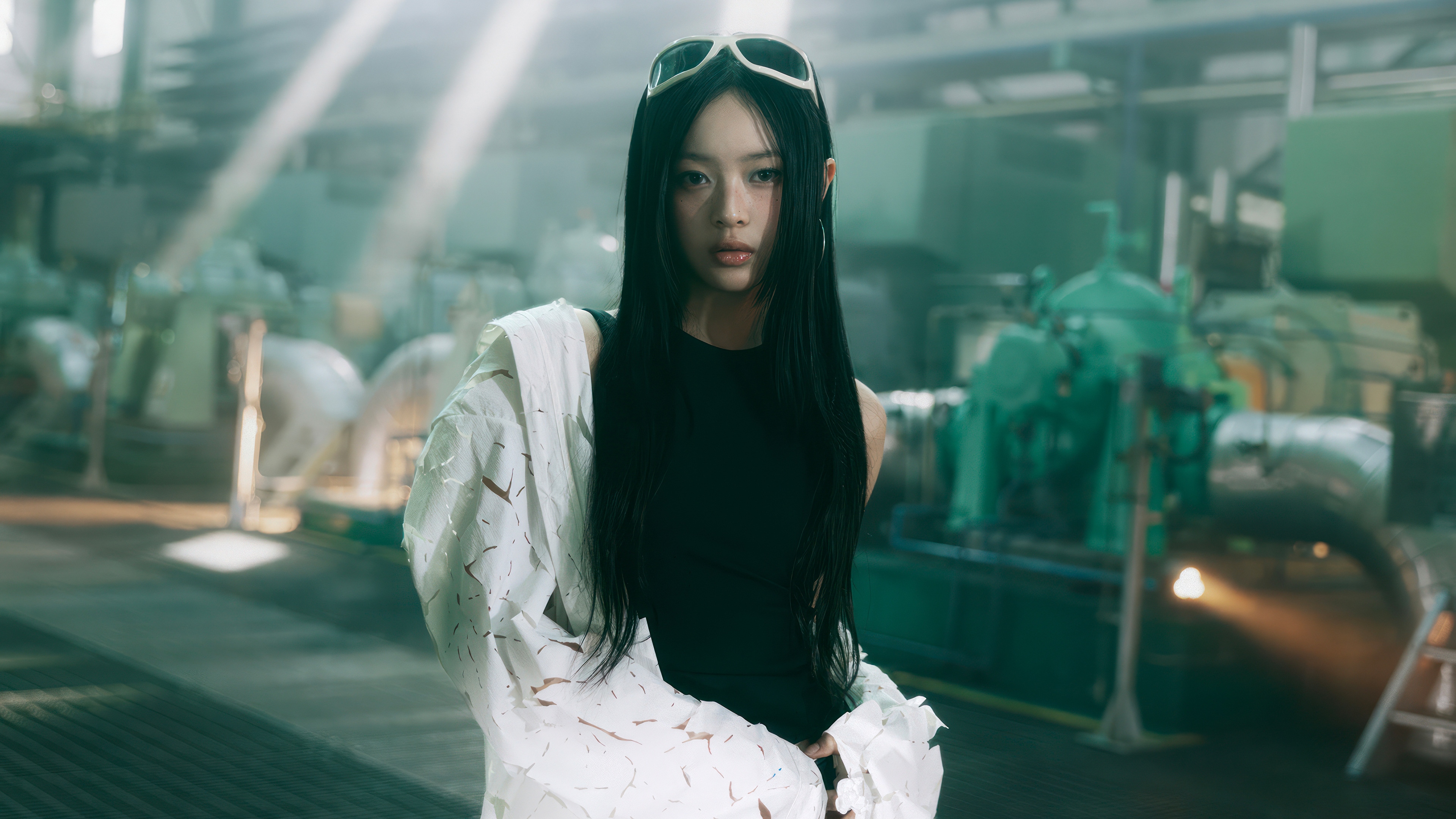 Hanni from NewJeans in a factory setting HD Wallpaper