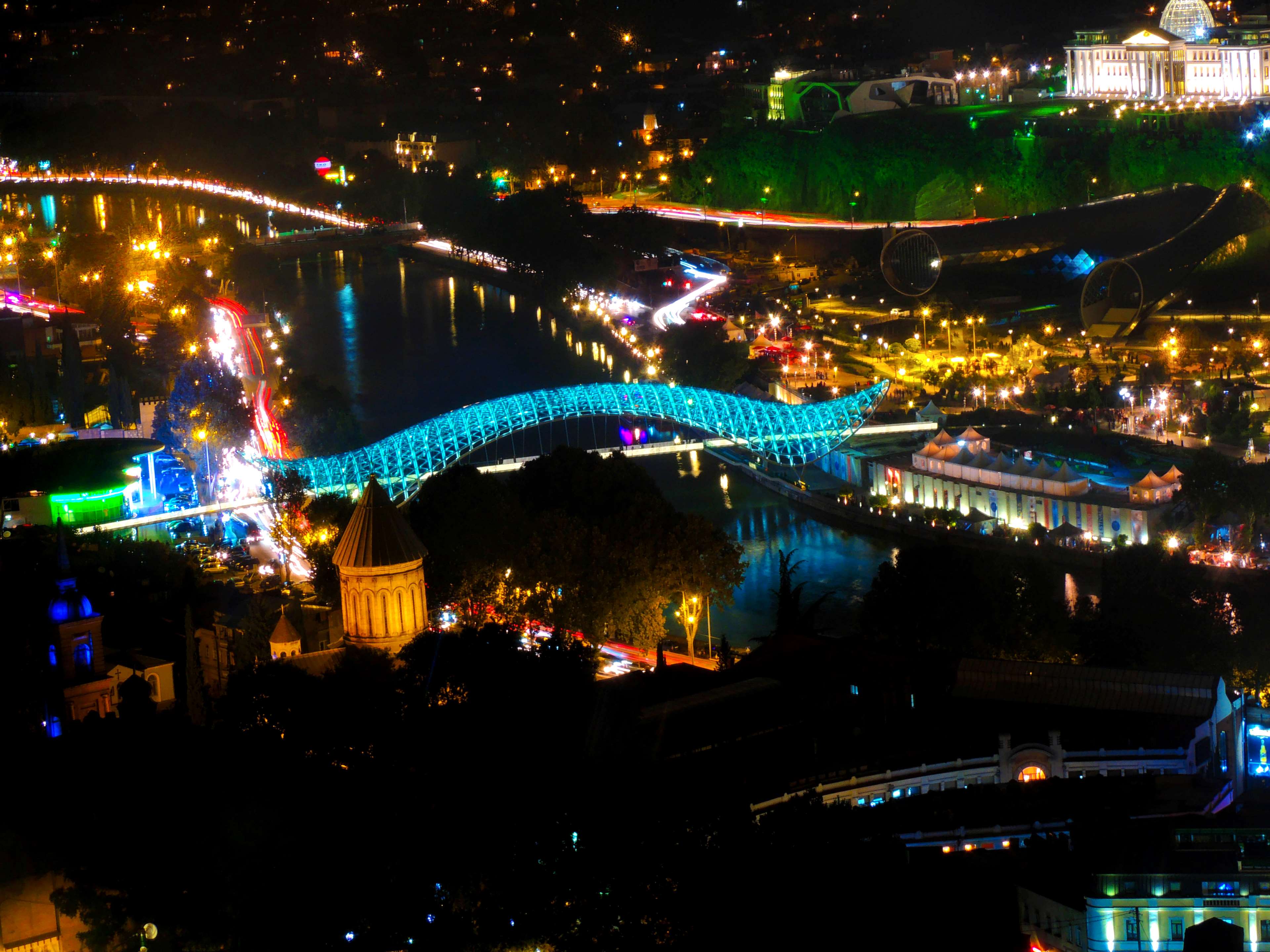 Tbilisi cityscape at night with illuminated bridges and buildings HD Wallpaper