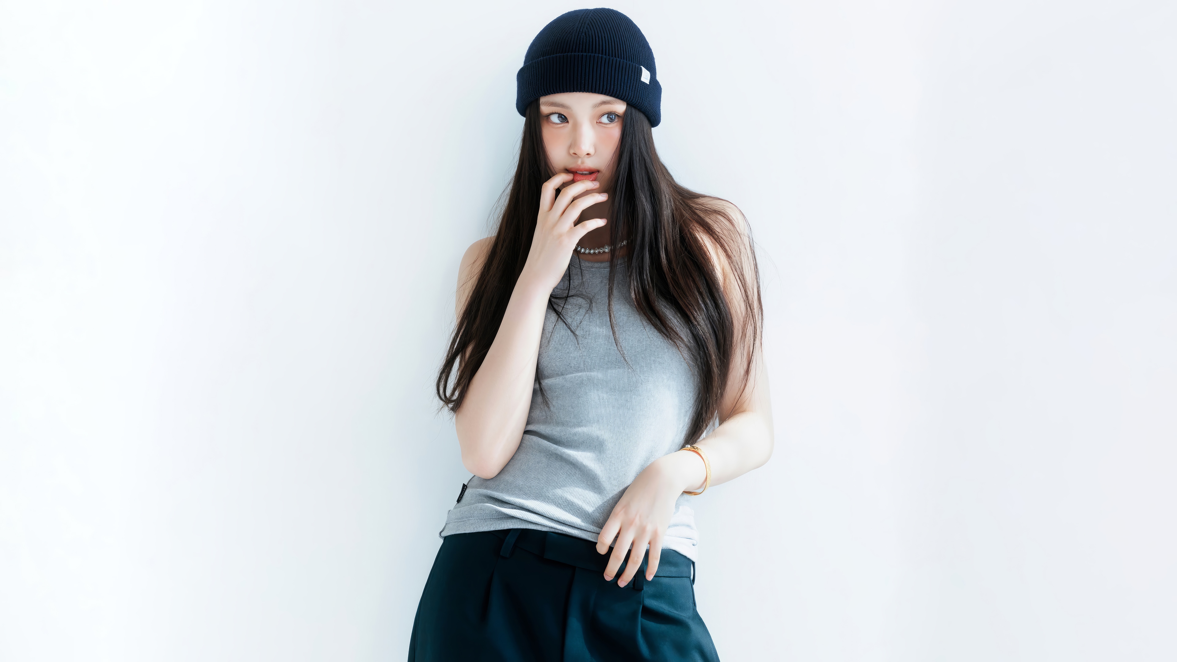 Hyein from NewJeans wearing a beanie and tank top HD Wallpaper