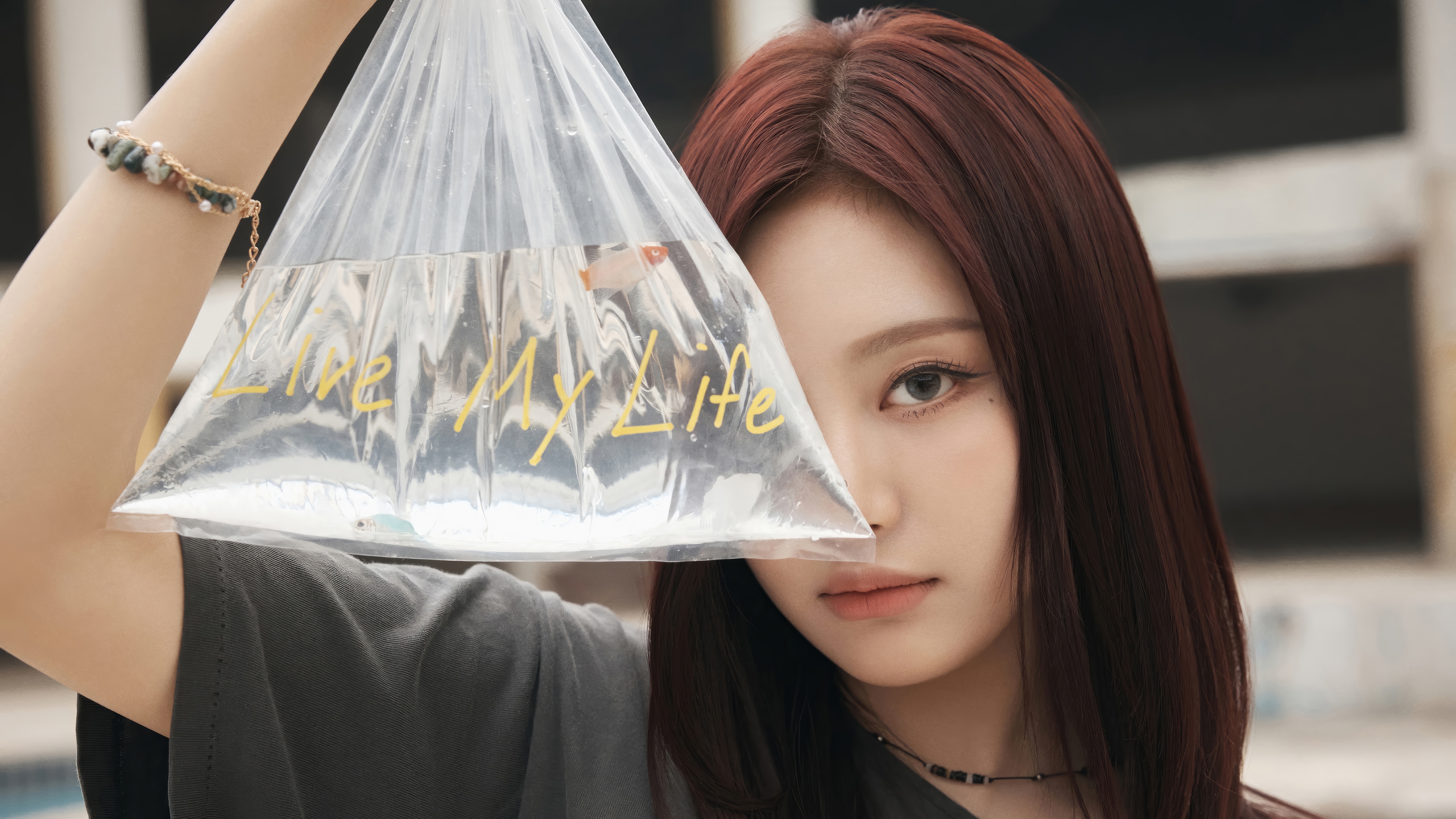 Ningning from Aespa holds a bag with 'Live My Life' written on it HD Wallpaper