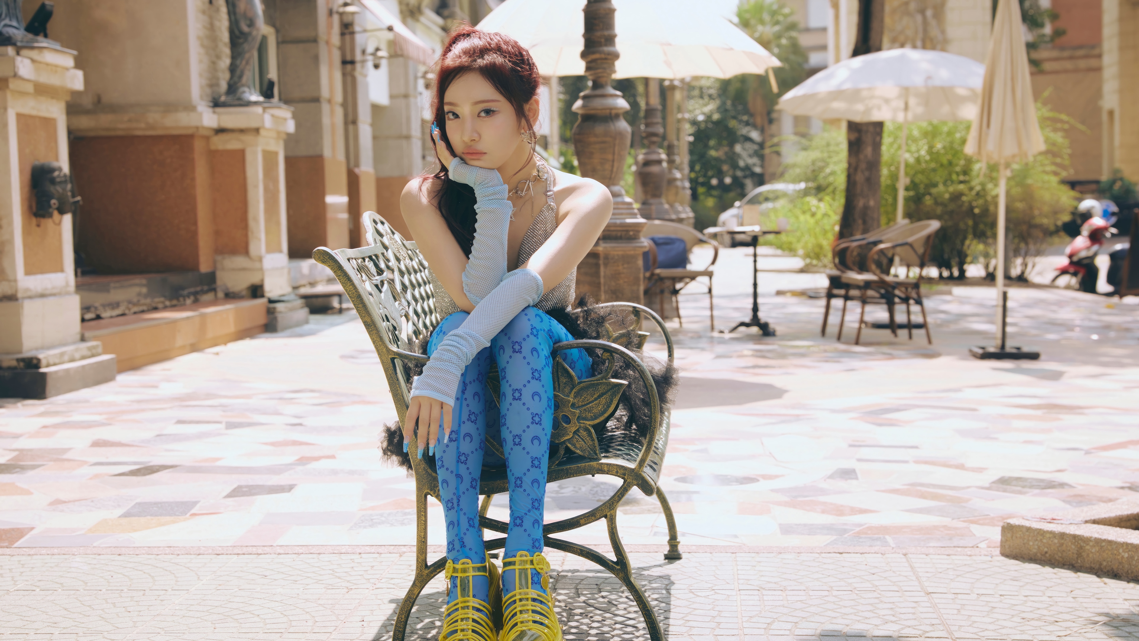 Ningning from Aespa sits on a bench outdoors HD Wallpaper