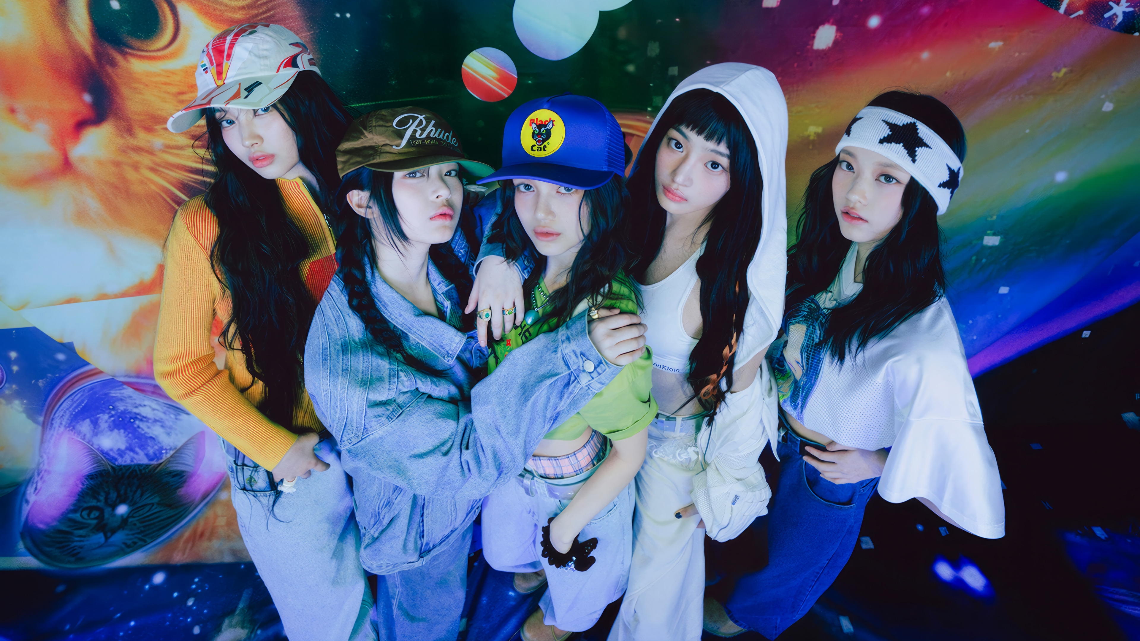 NewJeans members posing in colorful outfits HD Wallpaper