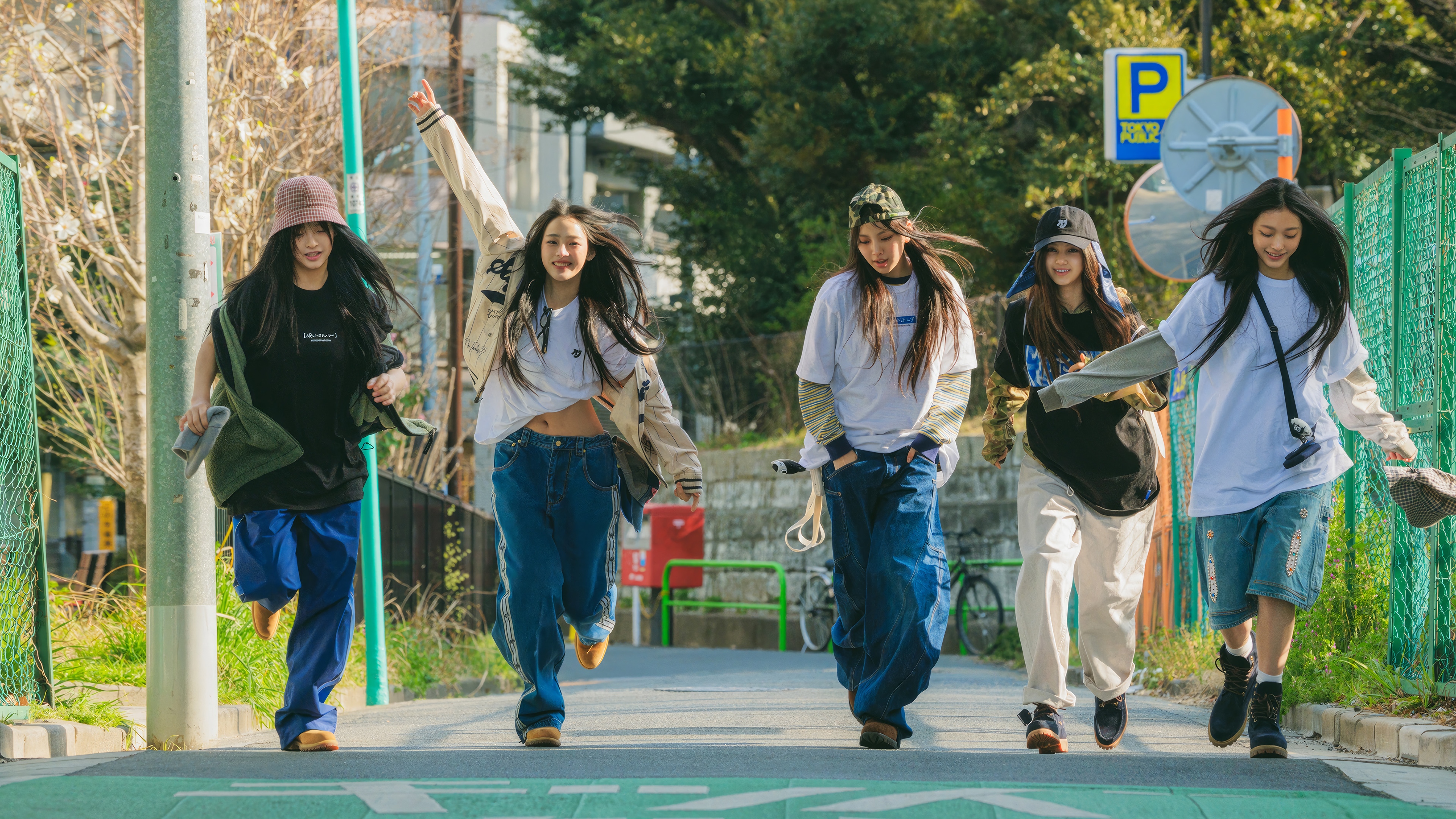 NewJeans running on a street in Japan HD Wallpaper