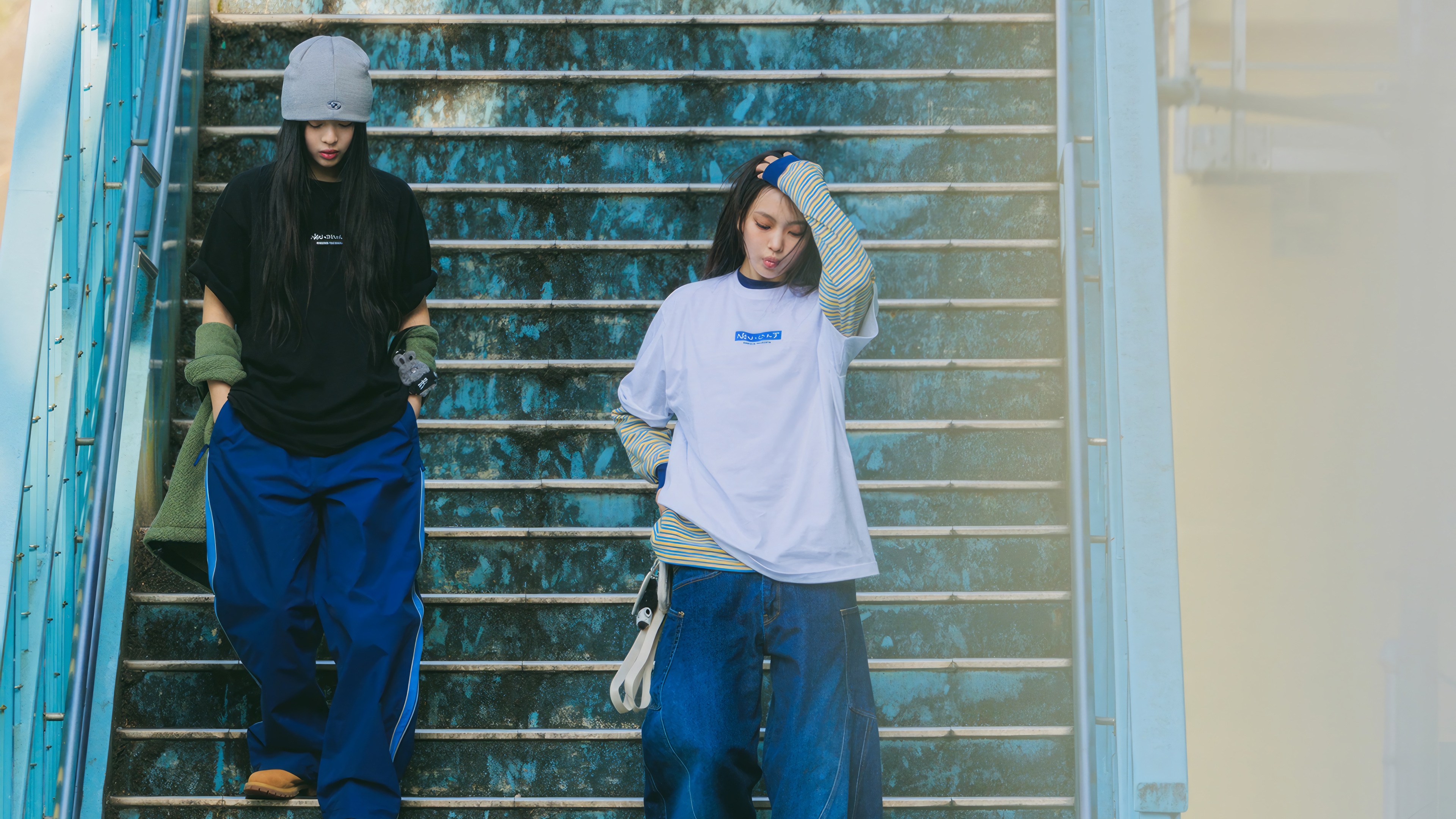Minji and Hyein from NewJeans on stairs HD Wallpaper