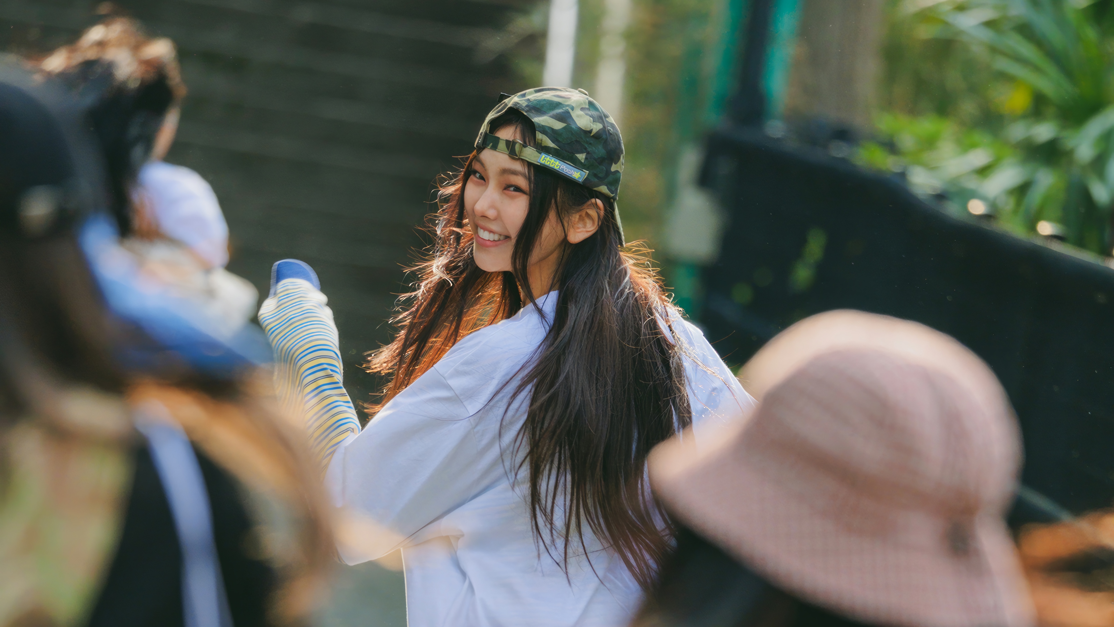 Hyein from NewJeans wearing a camouflage hat HD Wallpaper