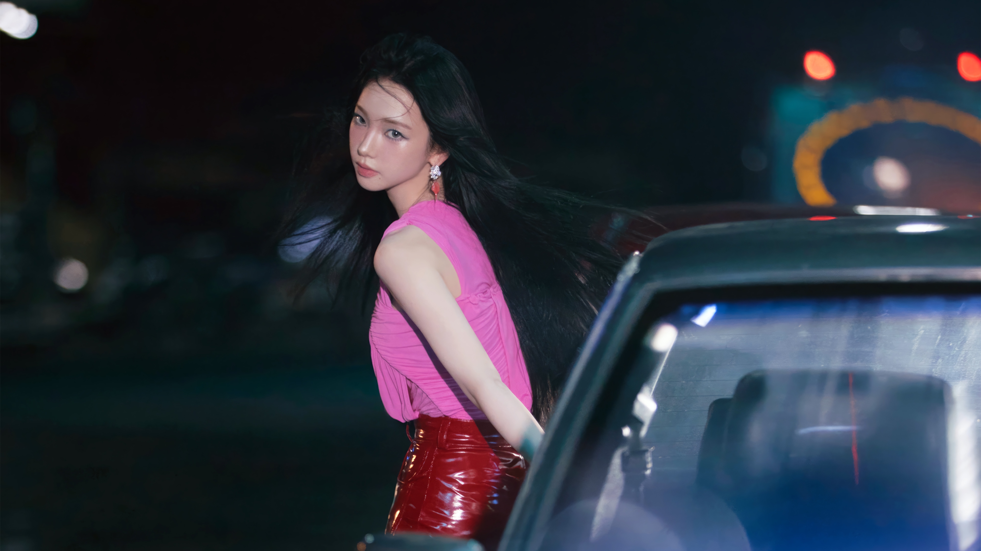 Karina from Aespa in a pink top and red skirt HD Wallpaper