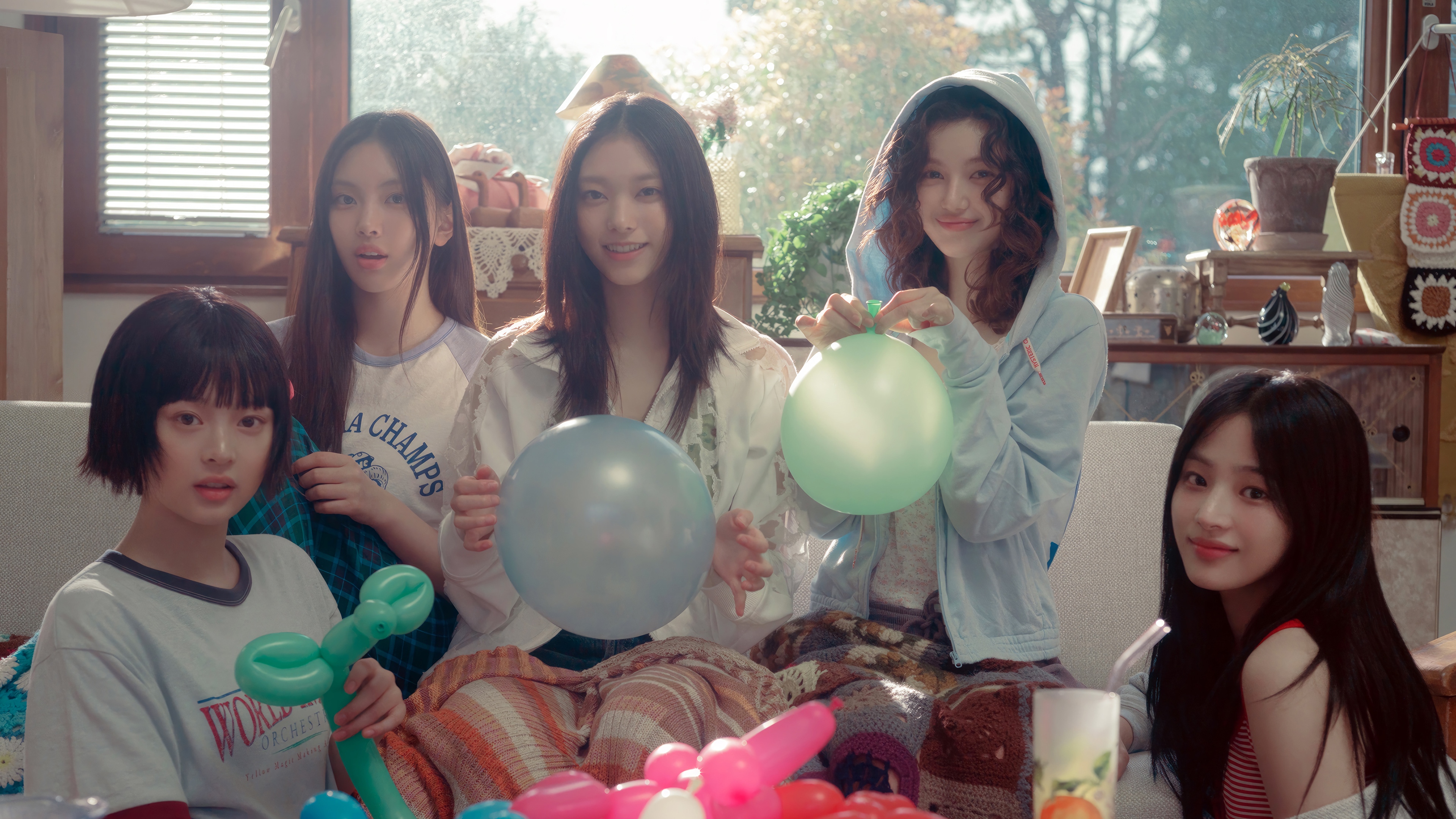 NewJeans members with balloons in a room HD Wallpaper