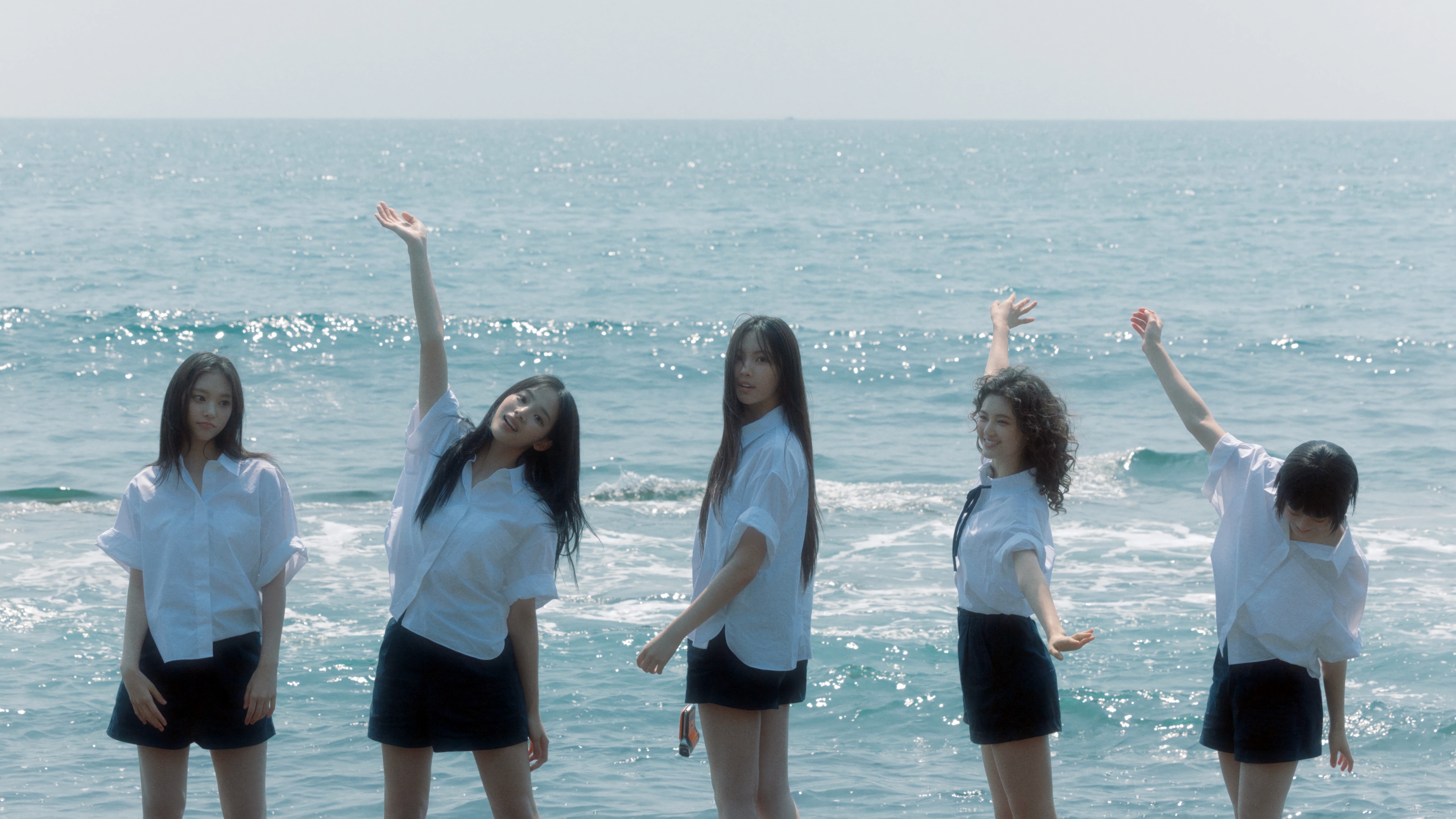NewJeans girls posing by the ocean in 4K HD Wallpaper