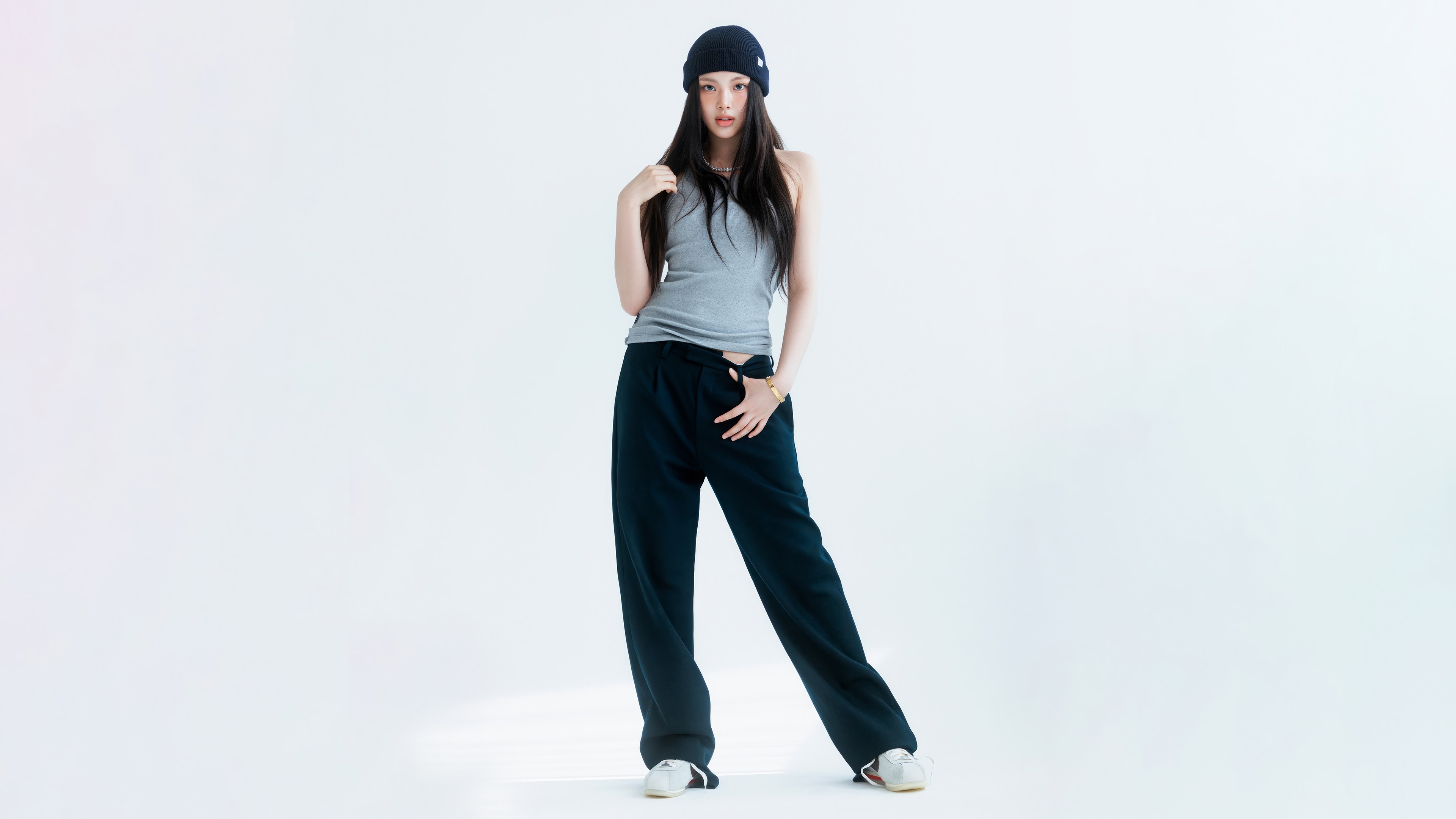 Hyein from NewJeans in a grey tank top and black pants HD Wallpaper