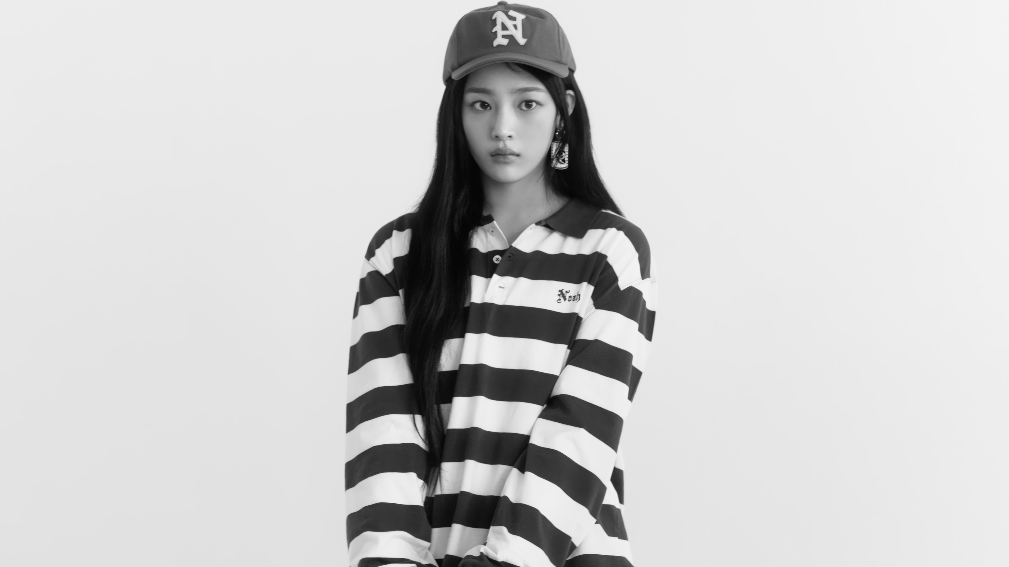 Minji from NewJeans wearing a striped shirt and cap HD Wallpaper