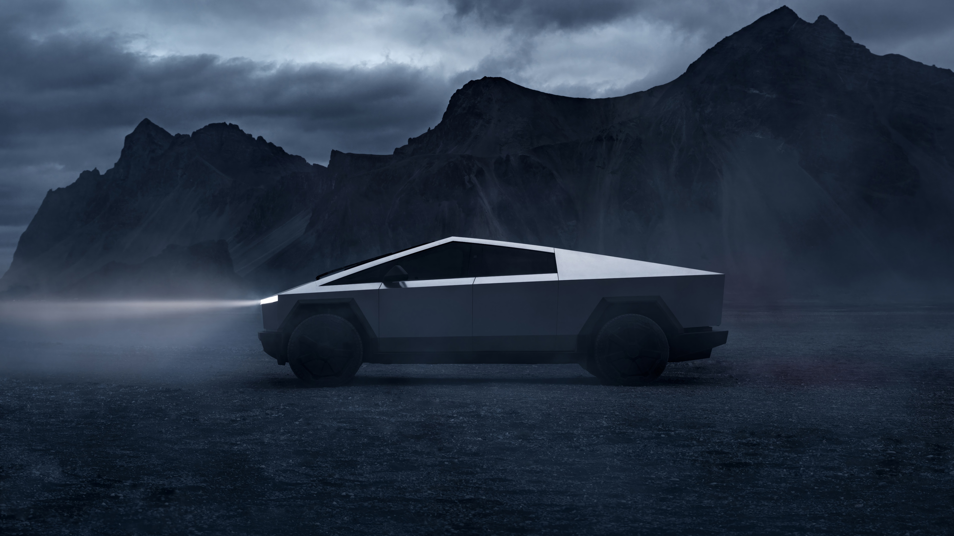 Tesla Cybertruck in a foggy, mountainous landscape HD Wallpaper