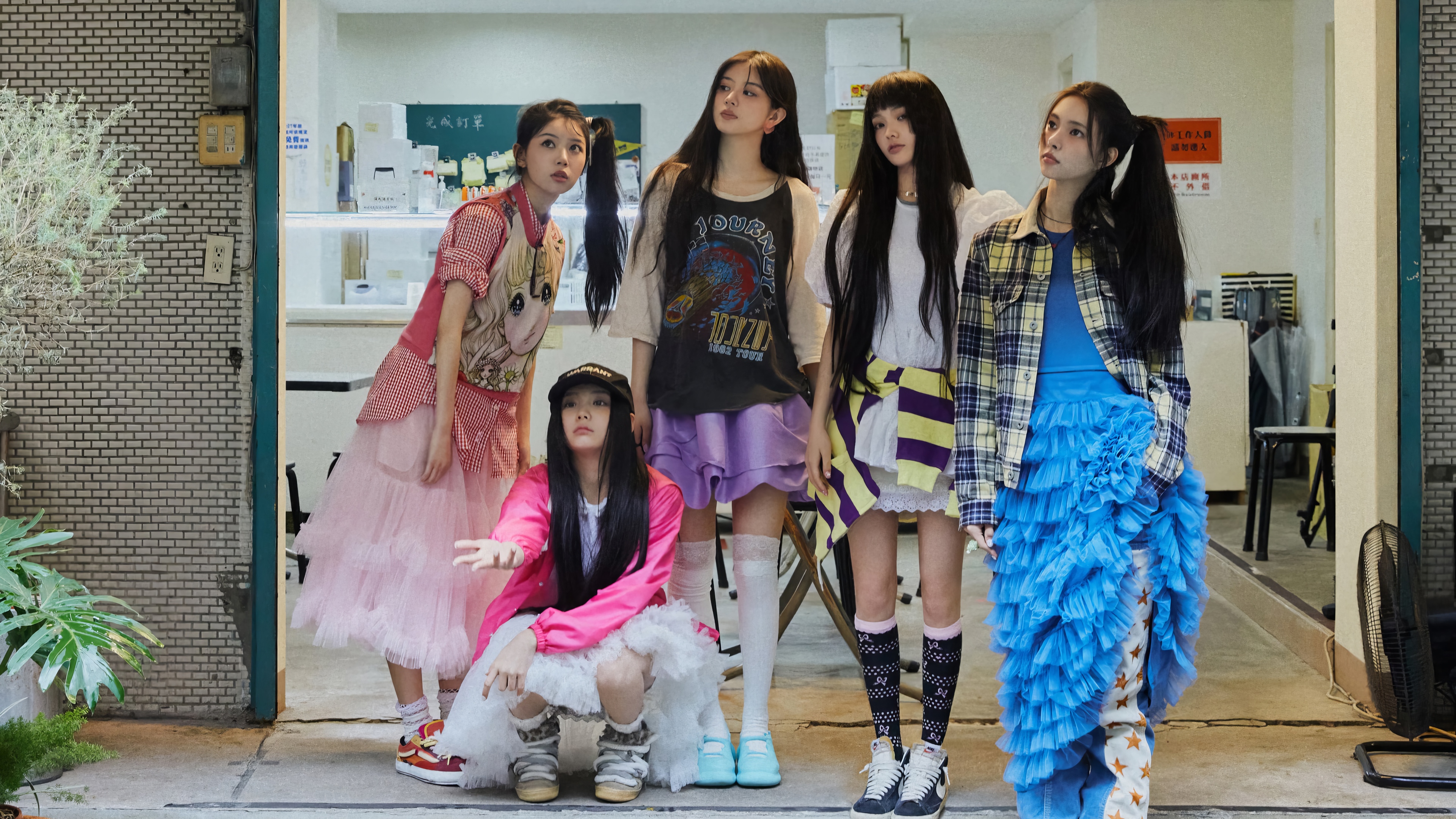 ILLIT Kpop group posing in front of a building HD Wallpaper