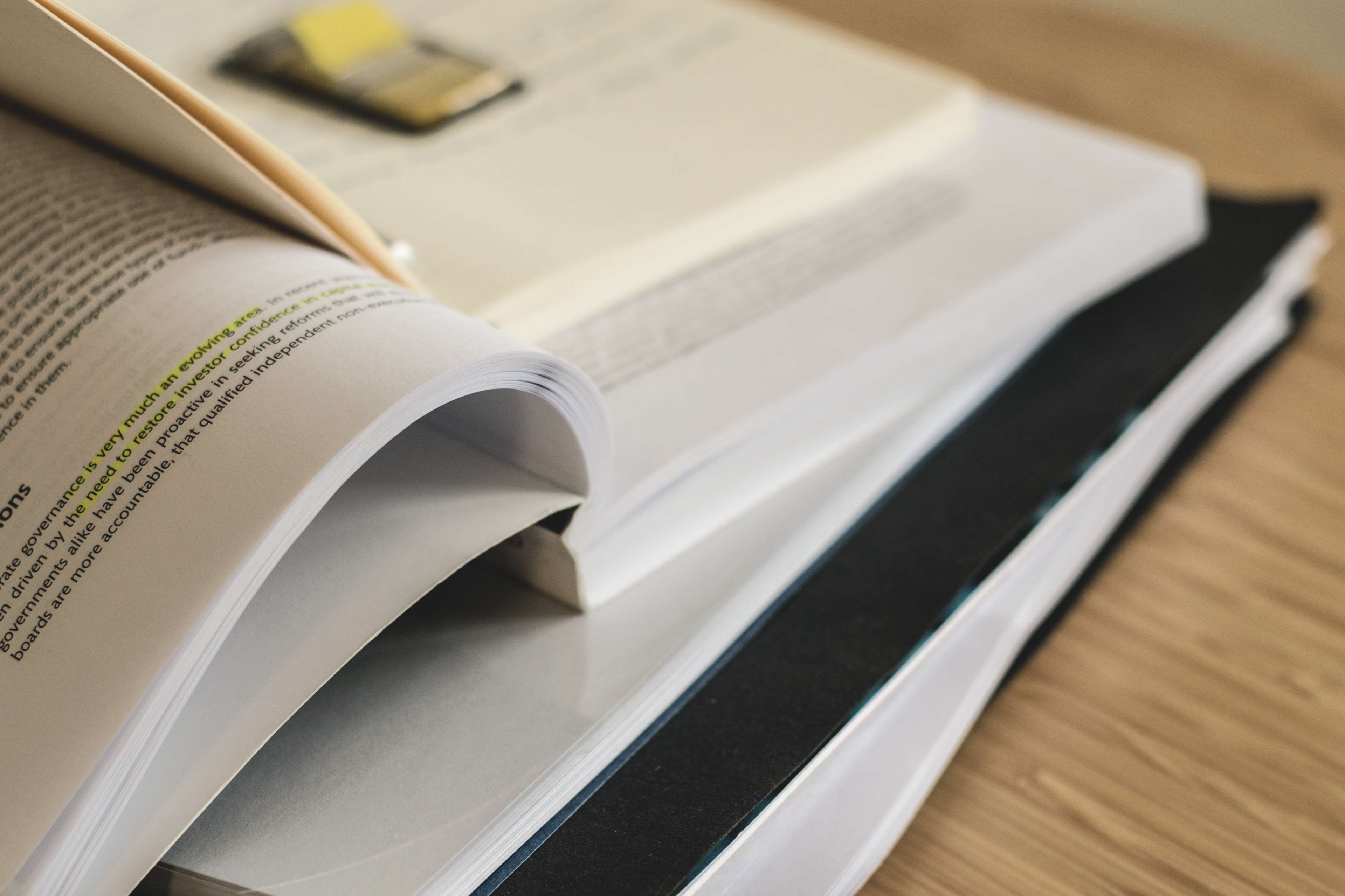 Stack of books with highlighted text HD Wallpaper