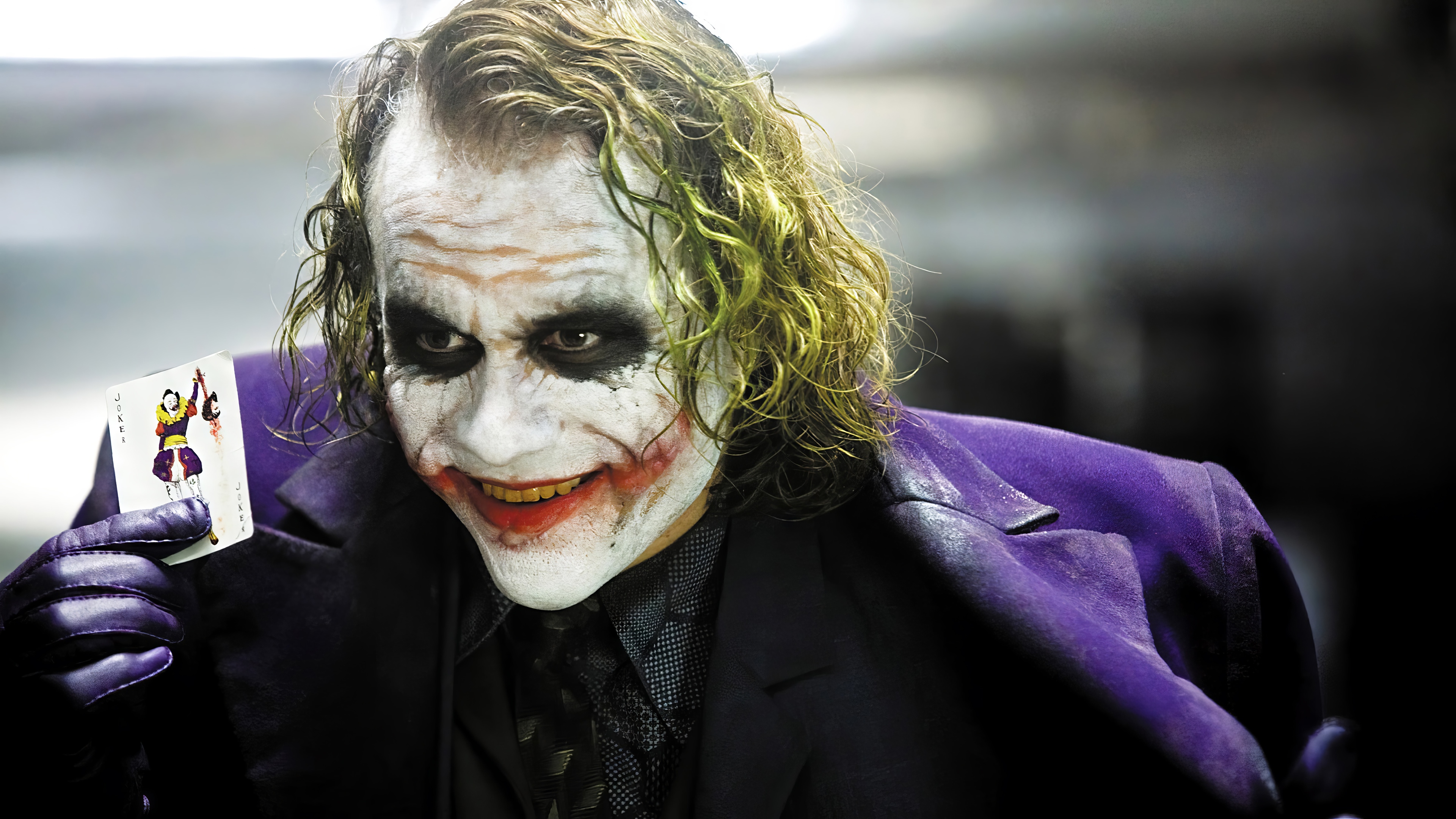 The Joker holding a playing card in The Dark Knight 4K HD Wallpaper