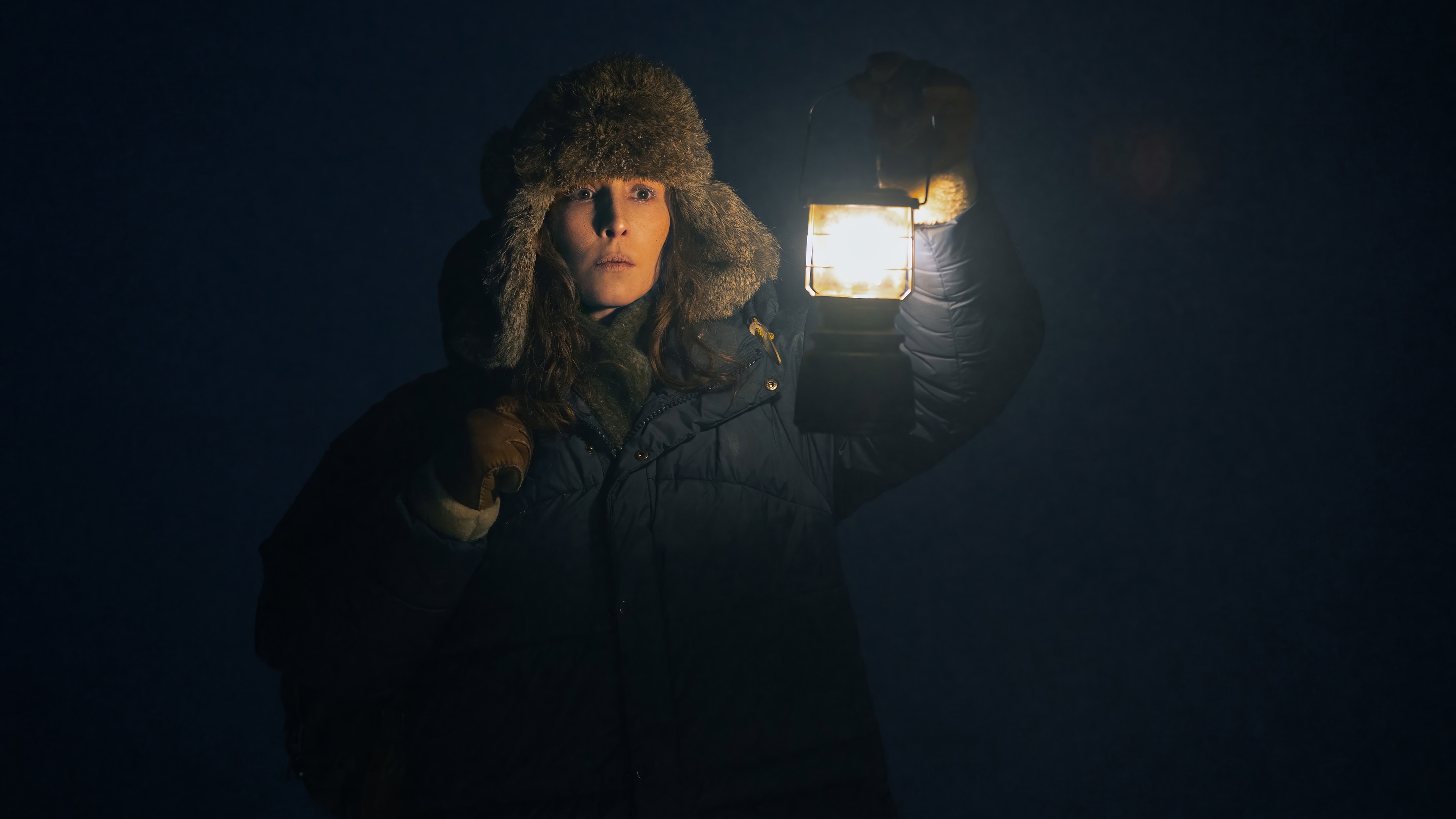 Noomi Rapace holding a lantern in the dark 4K HD Wallpaper