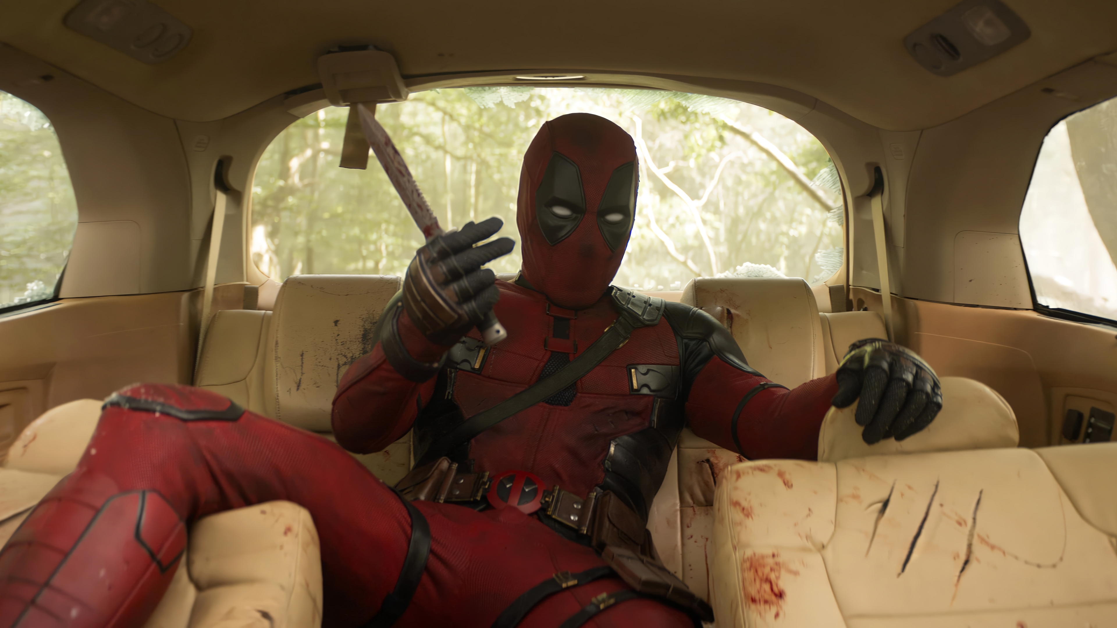 Deadpool in a car holding an axe 4K HD Wallpaper