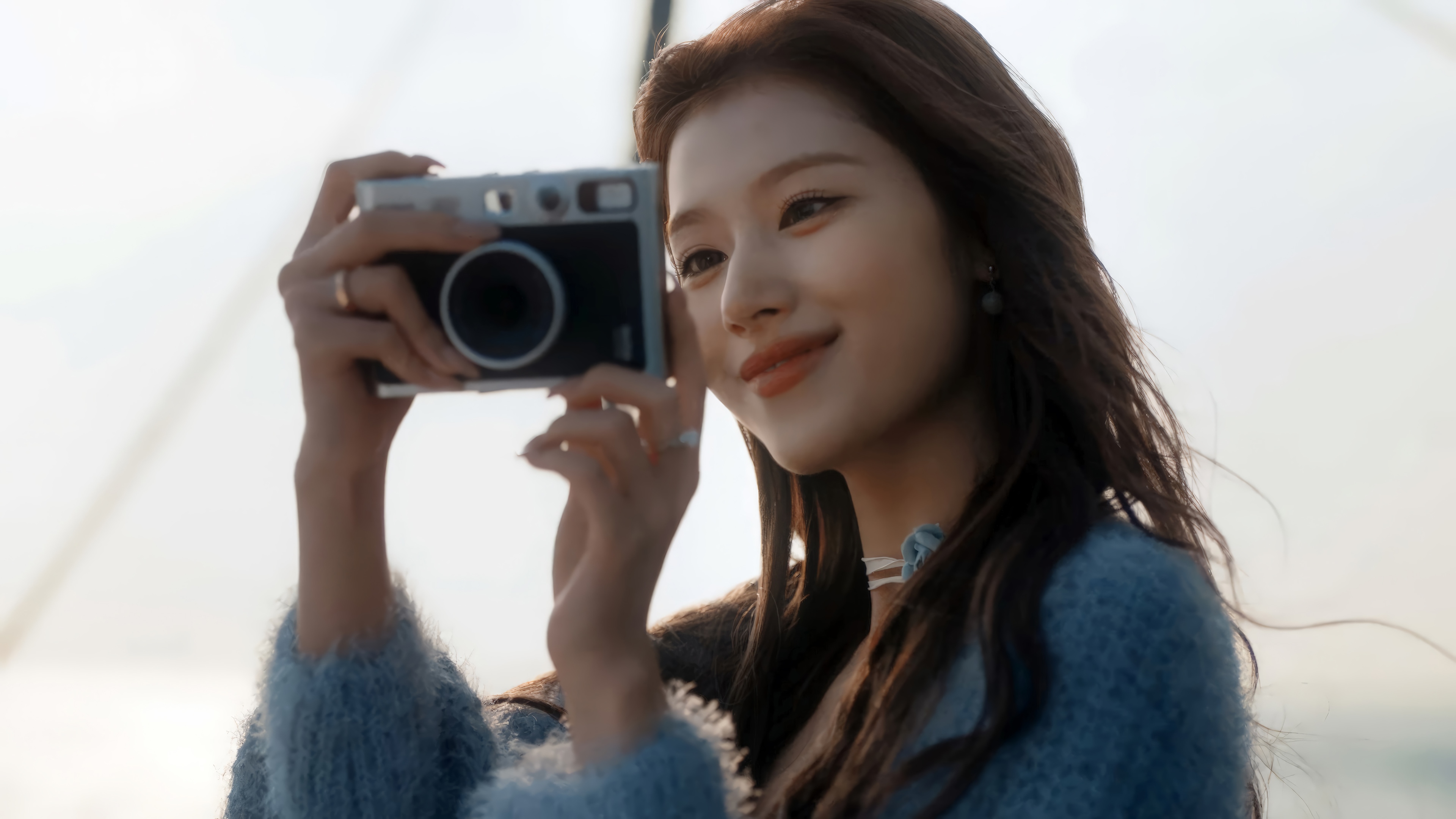Sana from TWICE holding a camera HD Wallpaper