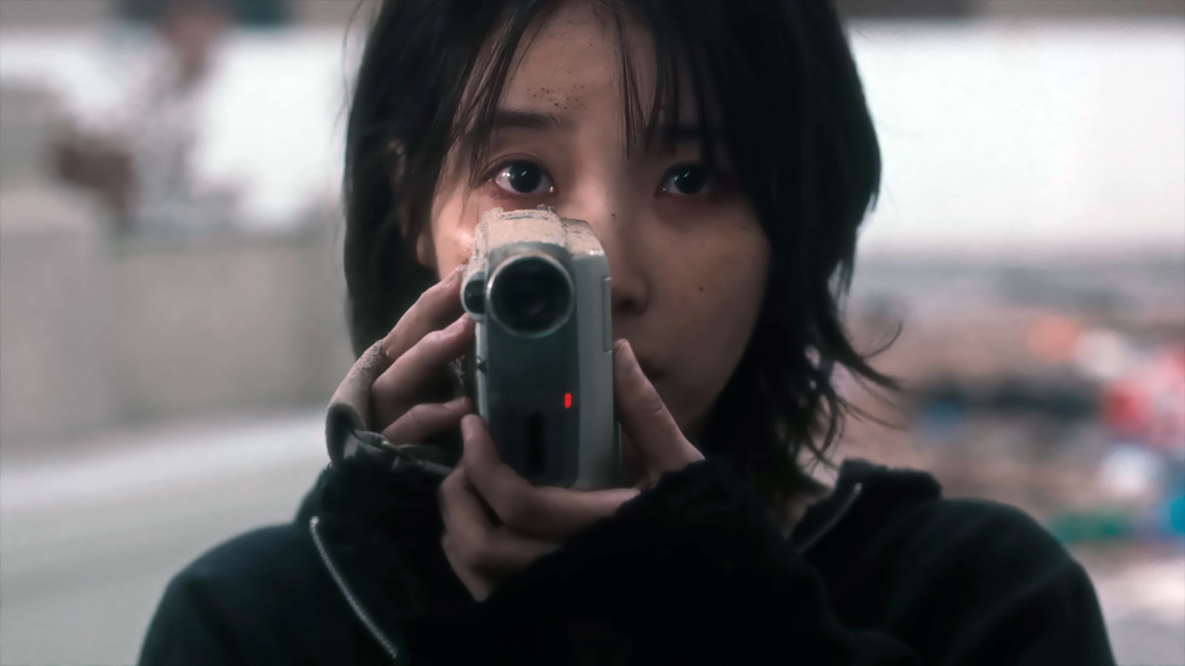 IU holding a camcorder in 4K HD Wallpaper
