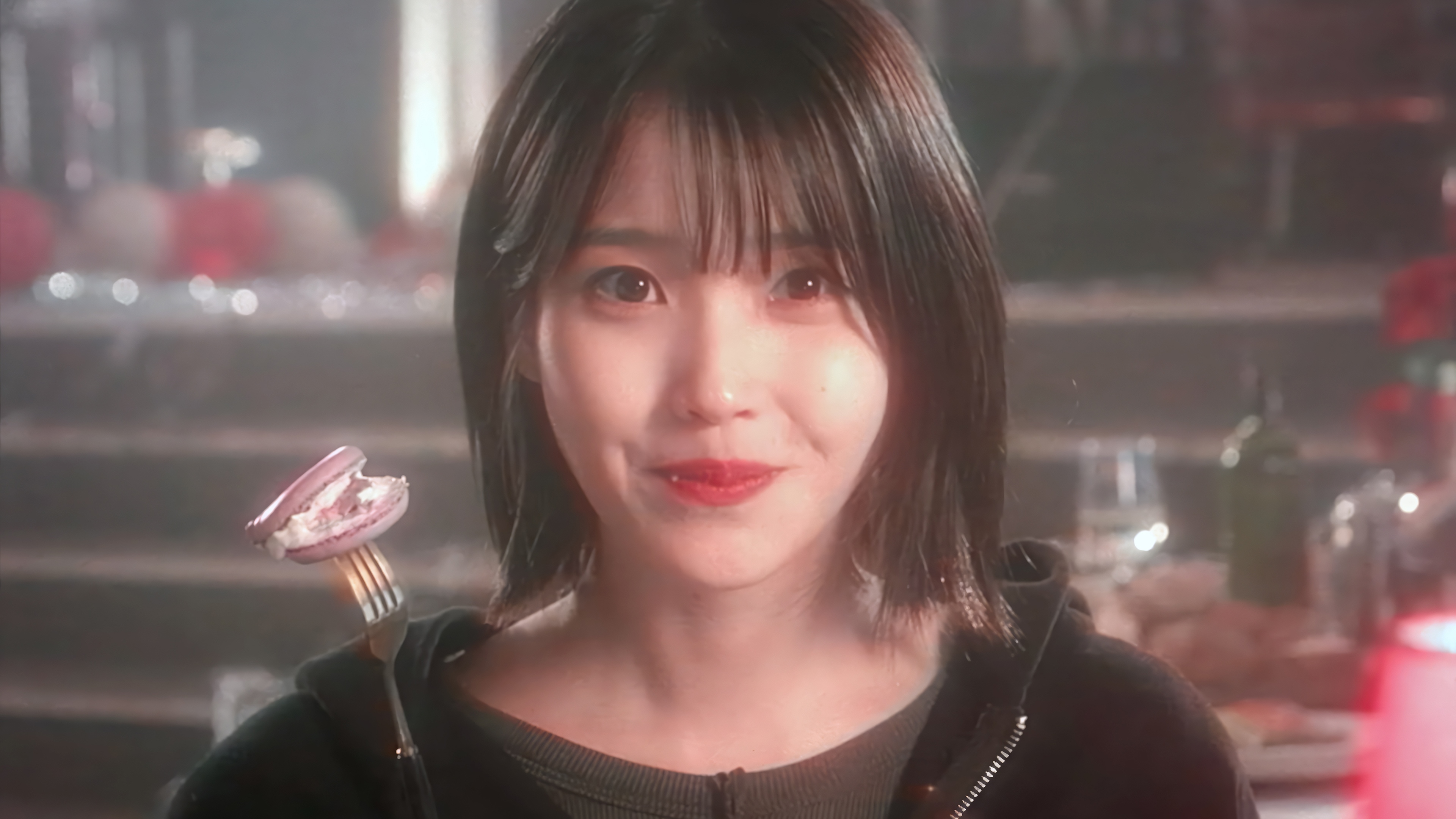 IU eating a macaron on a fork in 4K HD Wallpaper