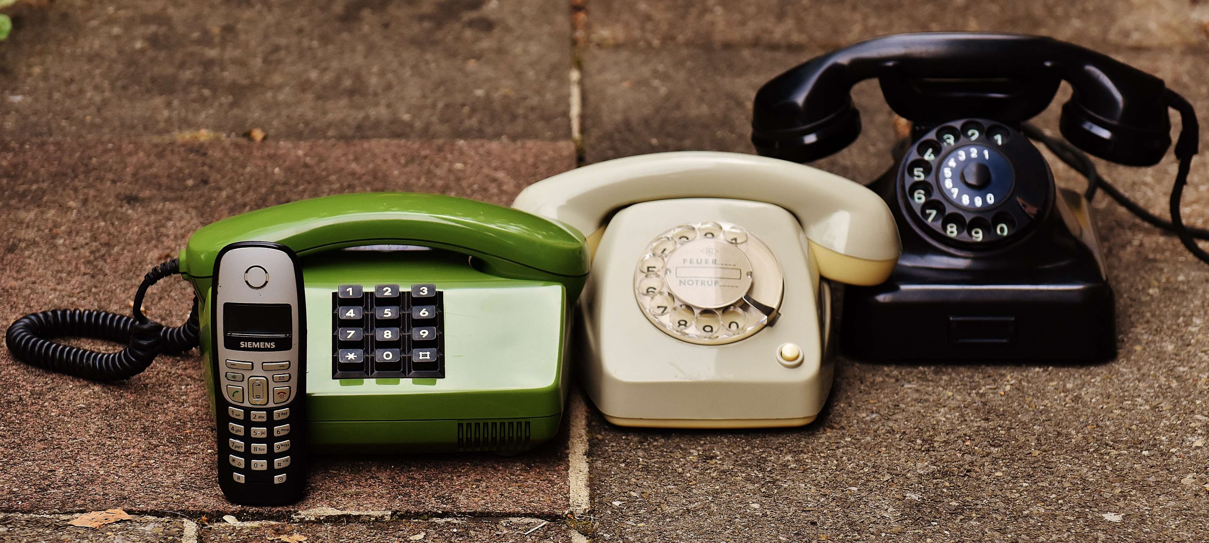 Vintage telephones: green, cream, and black rotary phones HD Wallpaper