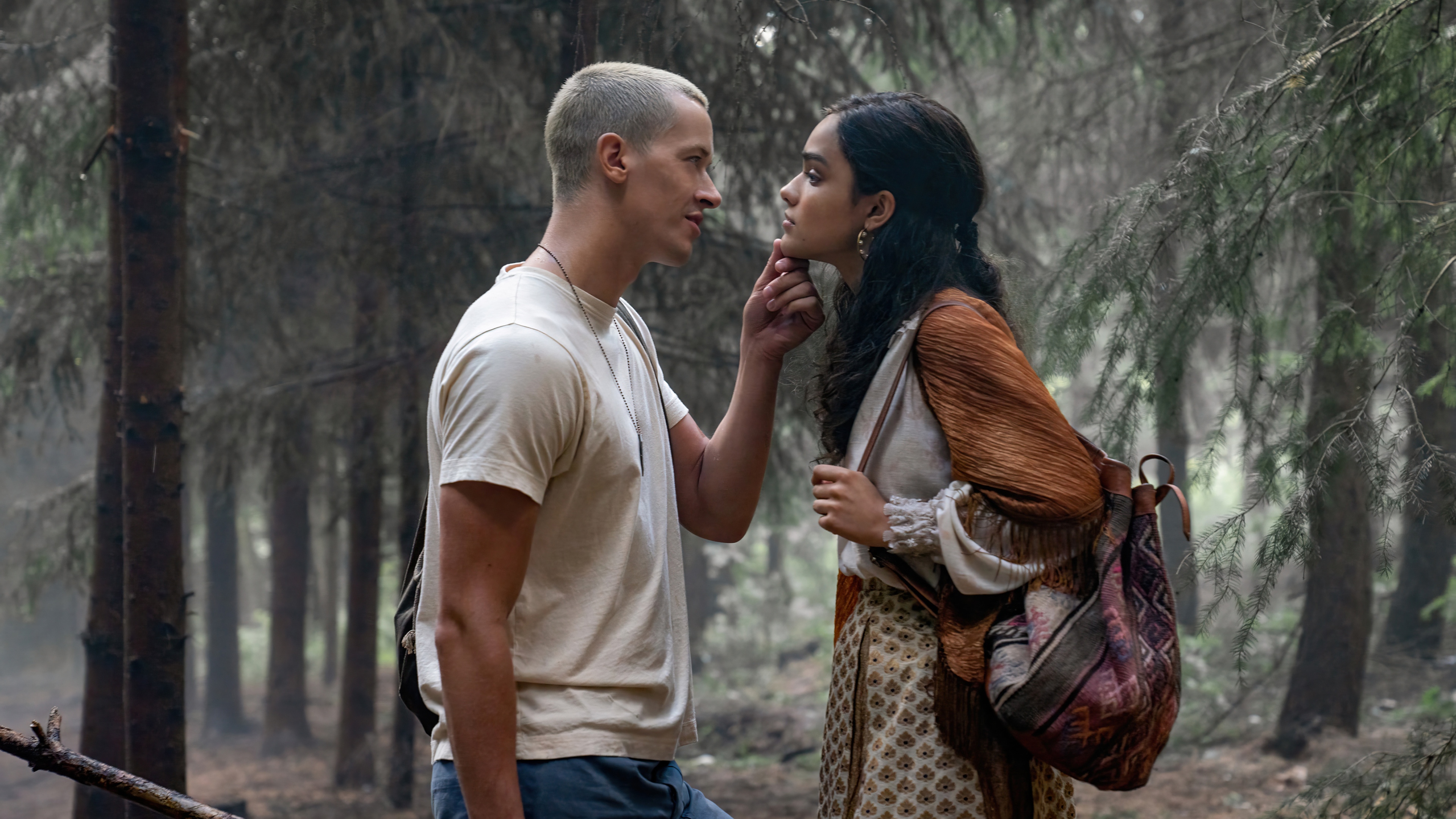 Coriolanus Snow and Lucy Gray Baird in a forest HD Wallpaper