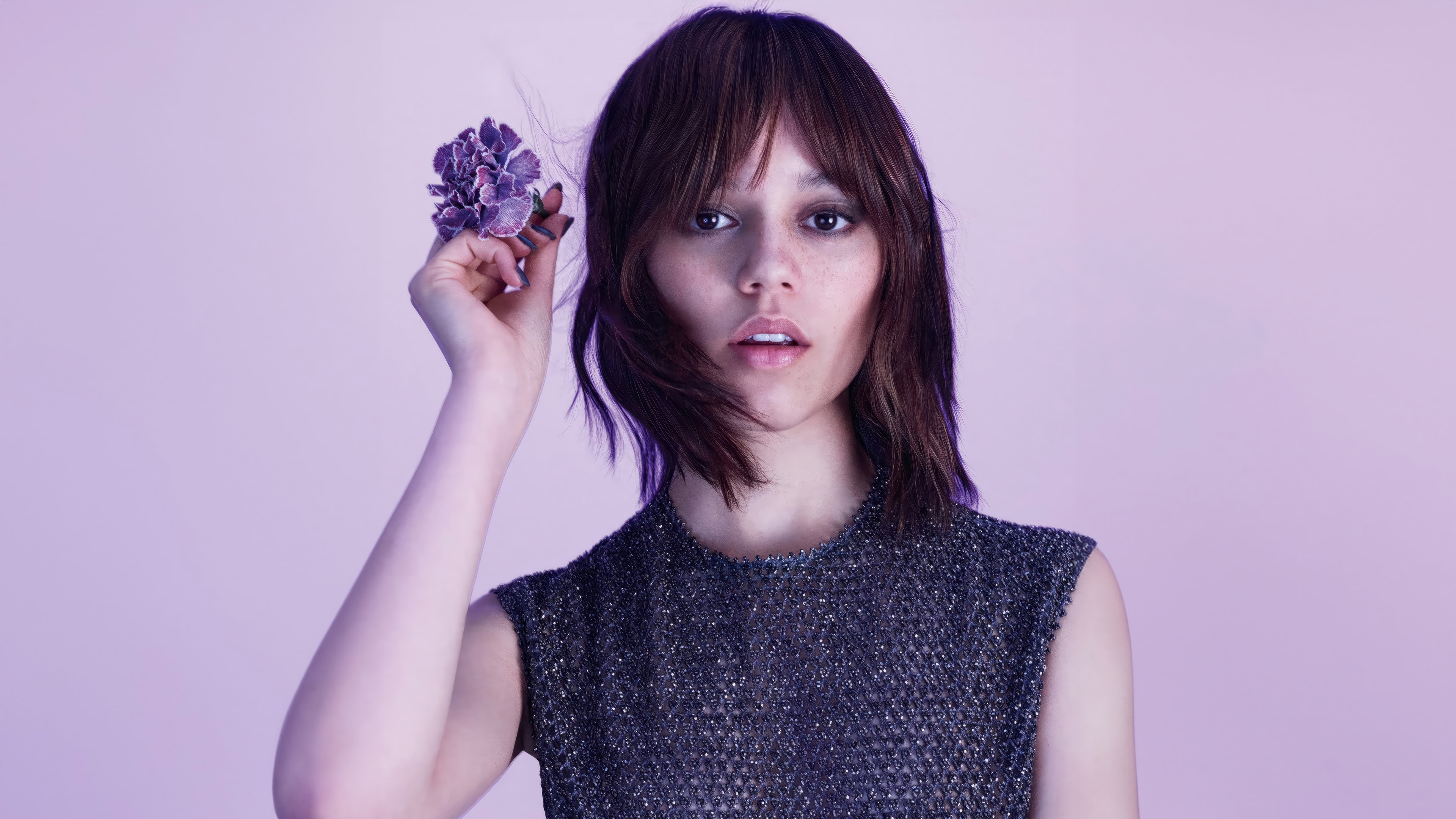 Jenna Ortega holding a purple flower HD Wallpaper