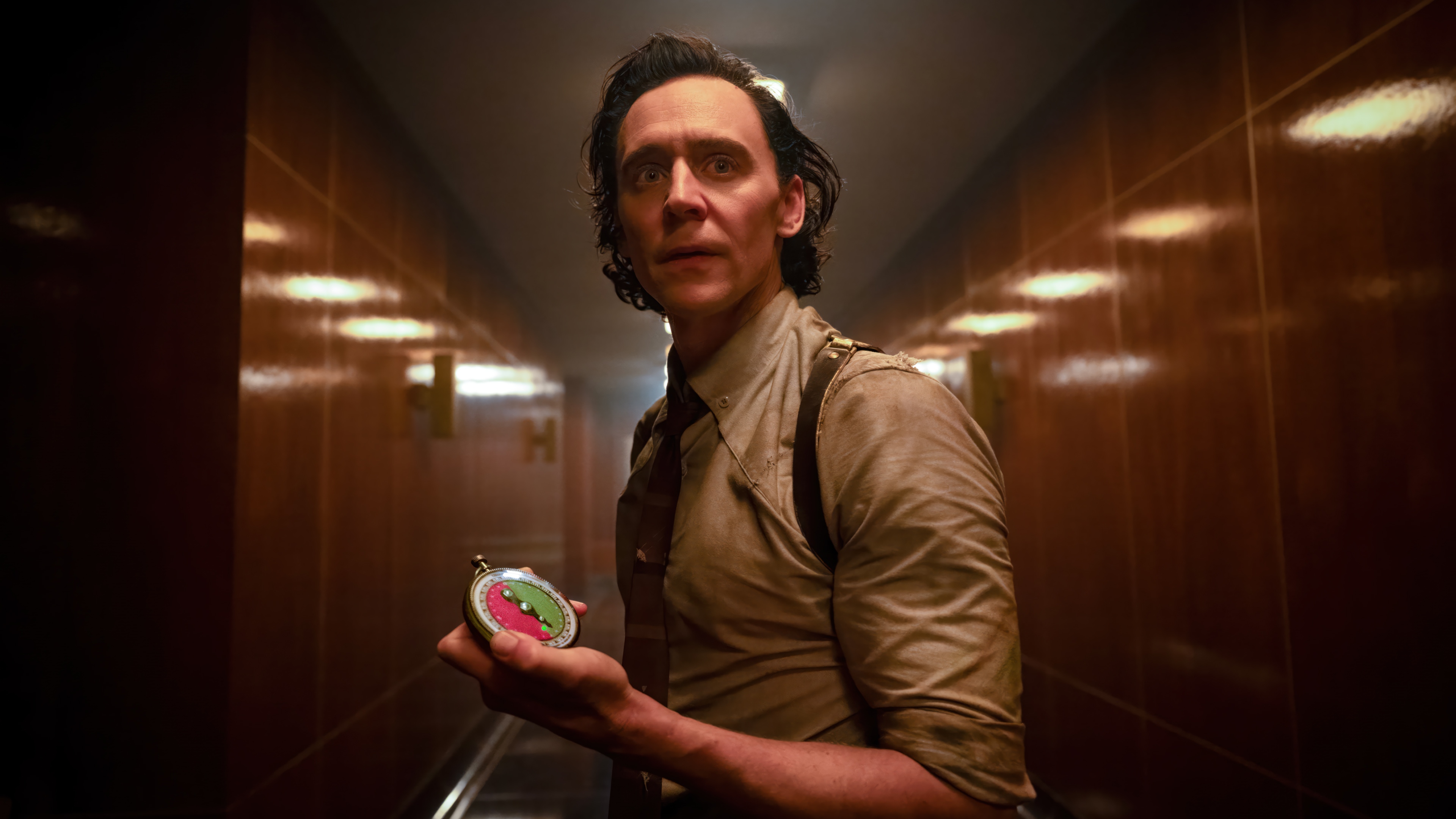 Loki holding a compass in a hallway 4K HD Wallpaper
