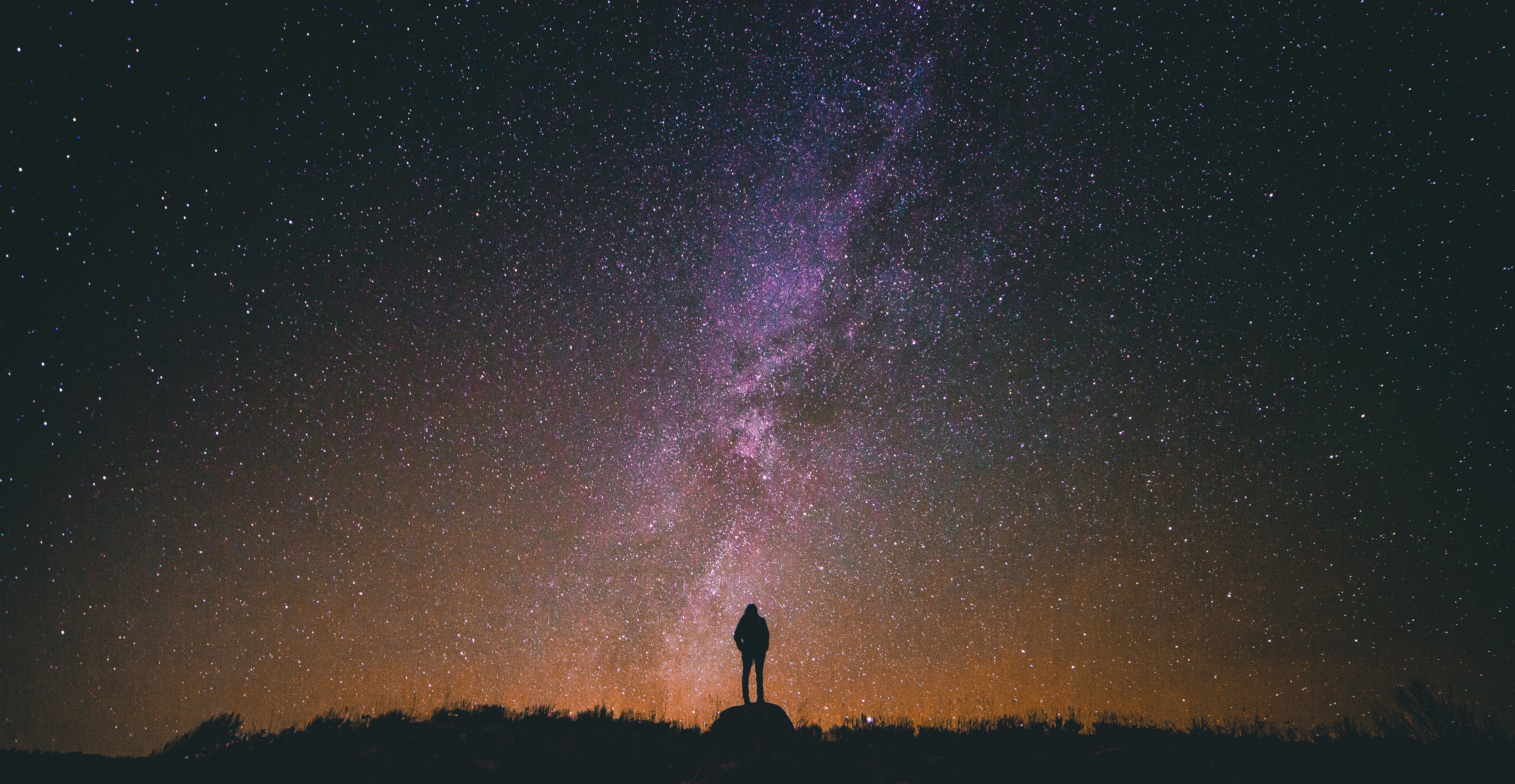 Man standing under a starry night sky HD Wallpaper