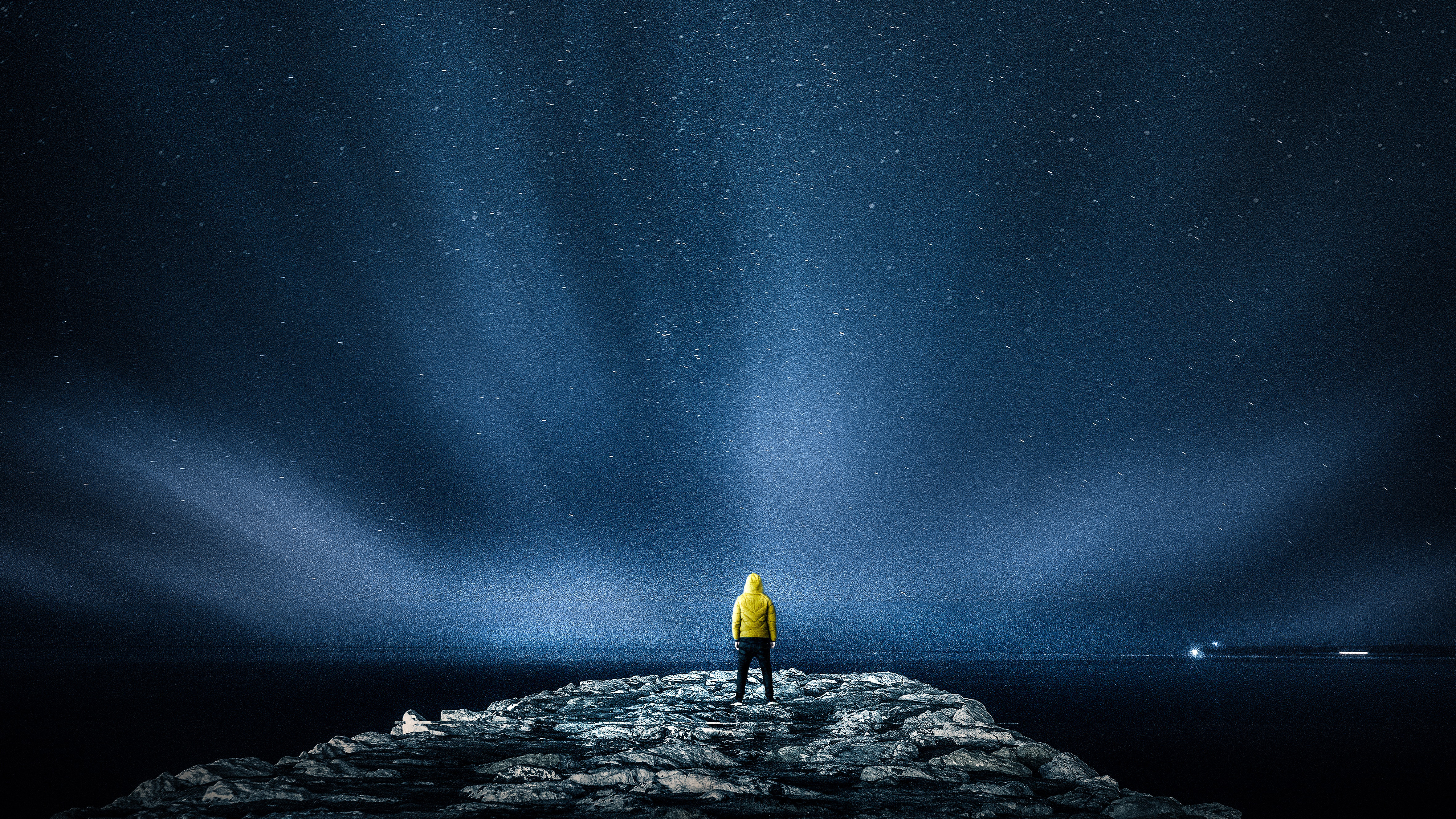 Person in yellow jacket under starry sky HD Wallpaper