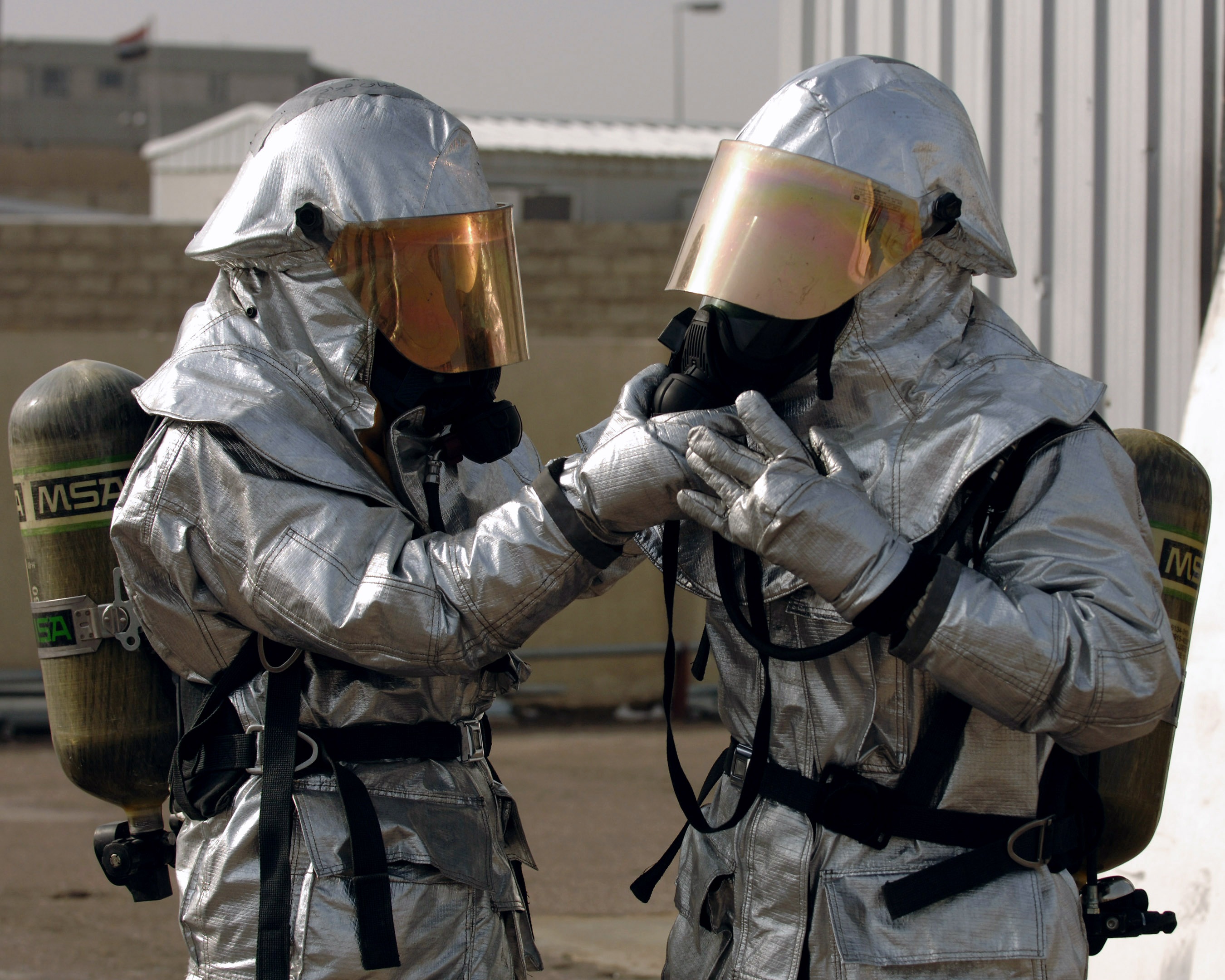 Two firefighters in silver suits with SCBA tanks HD Wallpaper