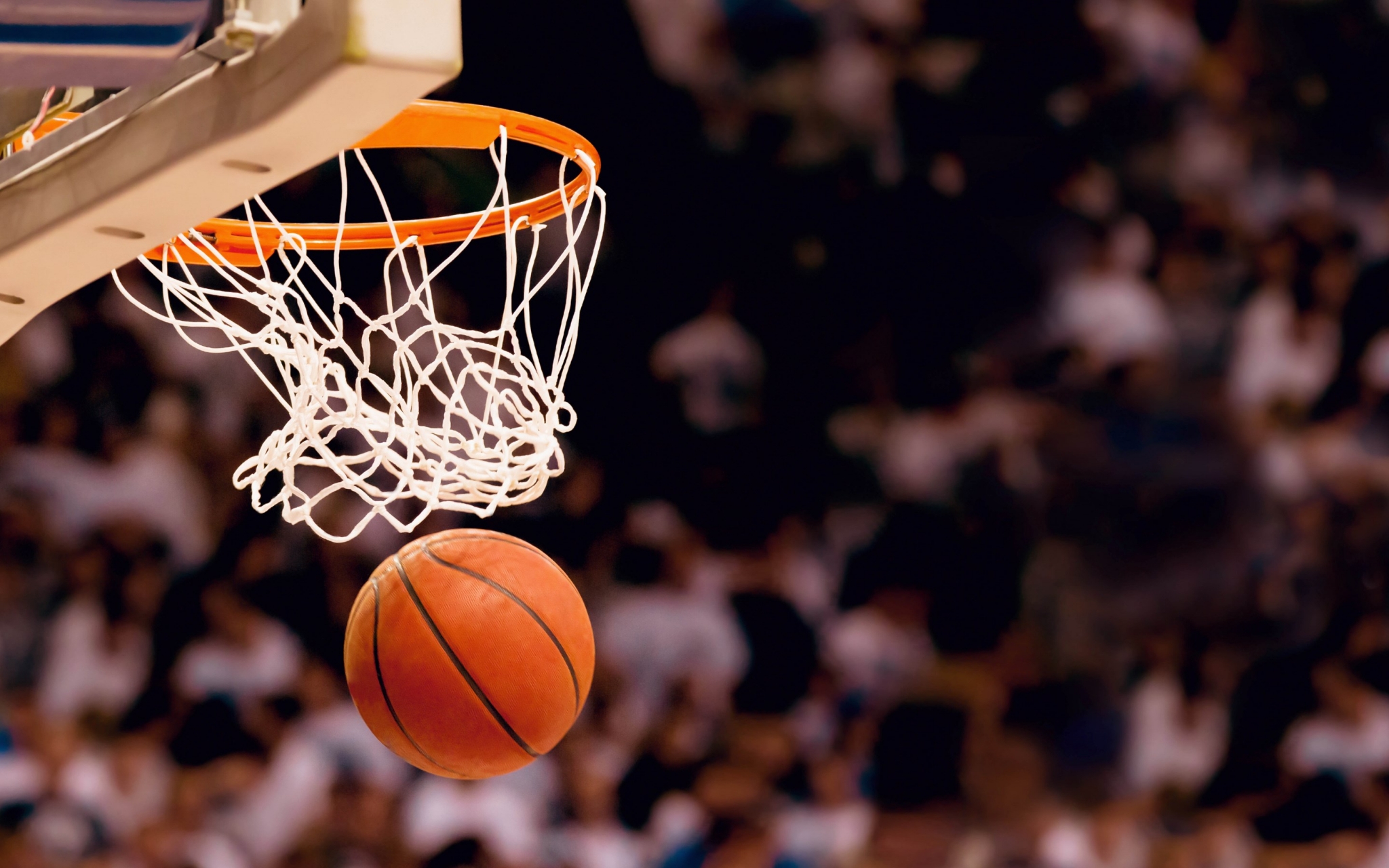 Basketball going into a hoop HD Wallpaper