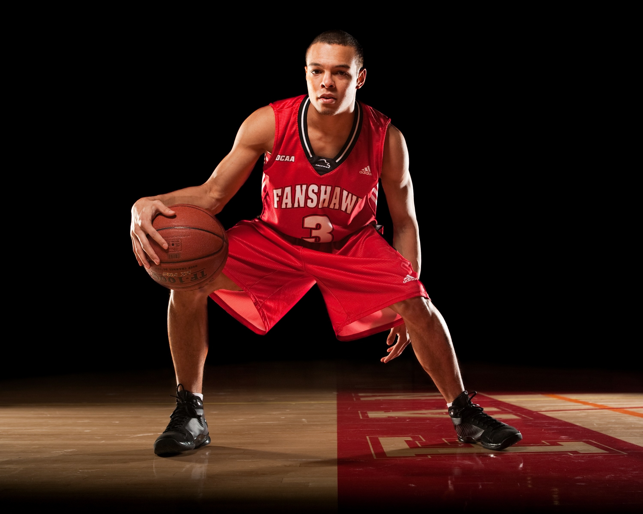 Basketball player dribbling on court HD Wallpaper