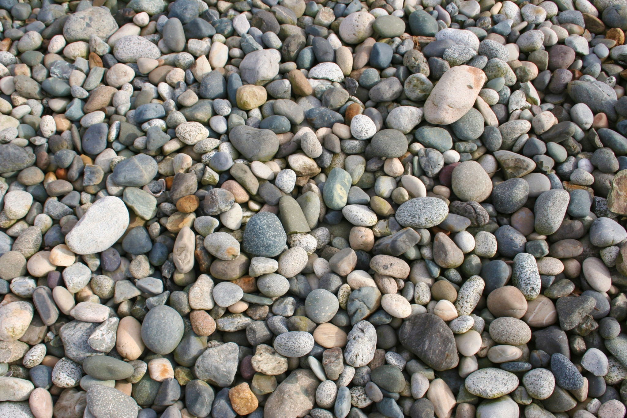 A pile of various sized and colored stones. HD Wallpaper