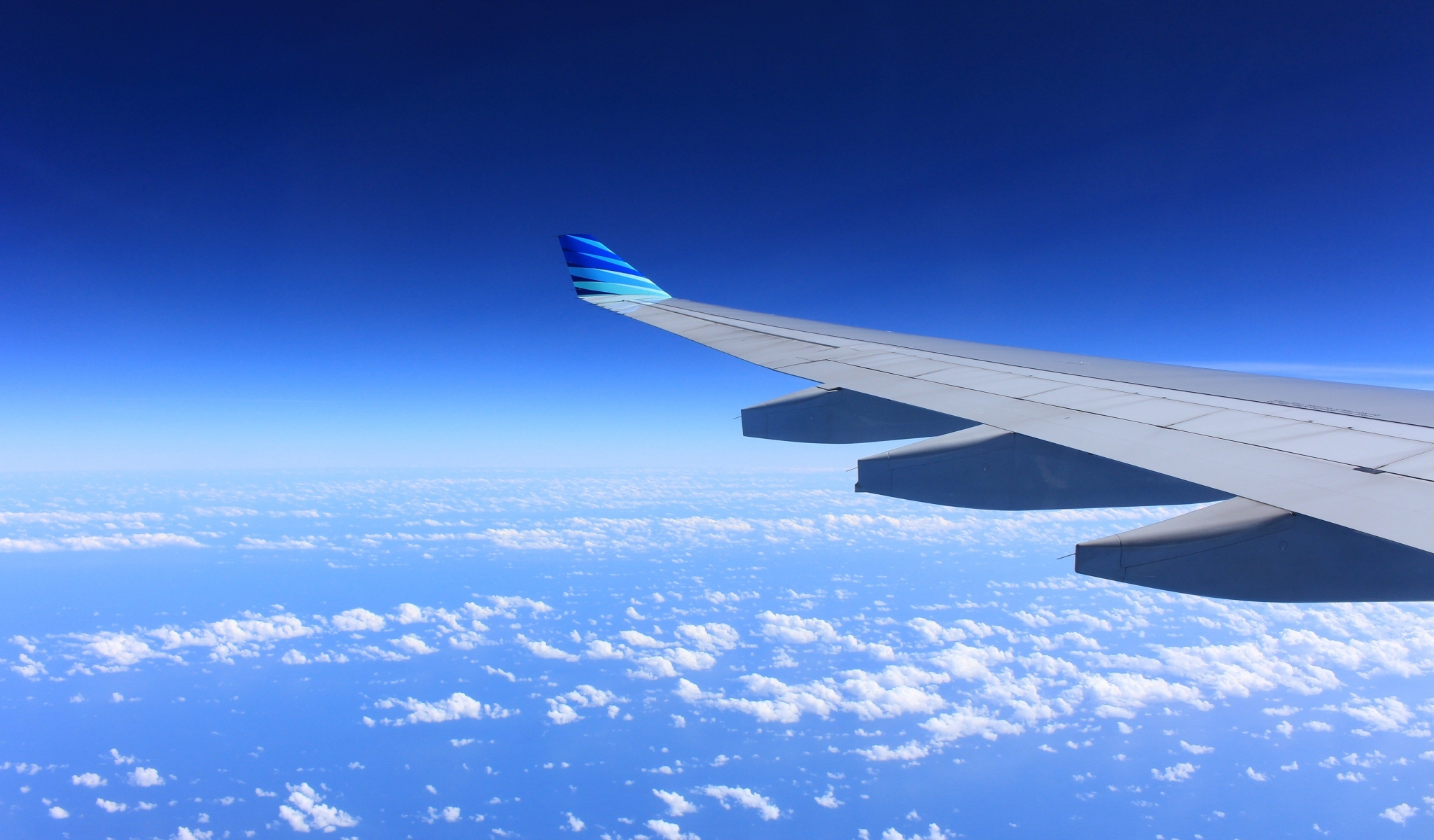 Airplane wing flying over clouds HD Wallpaper