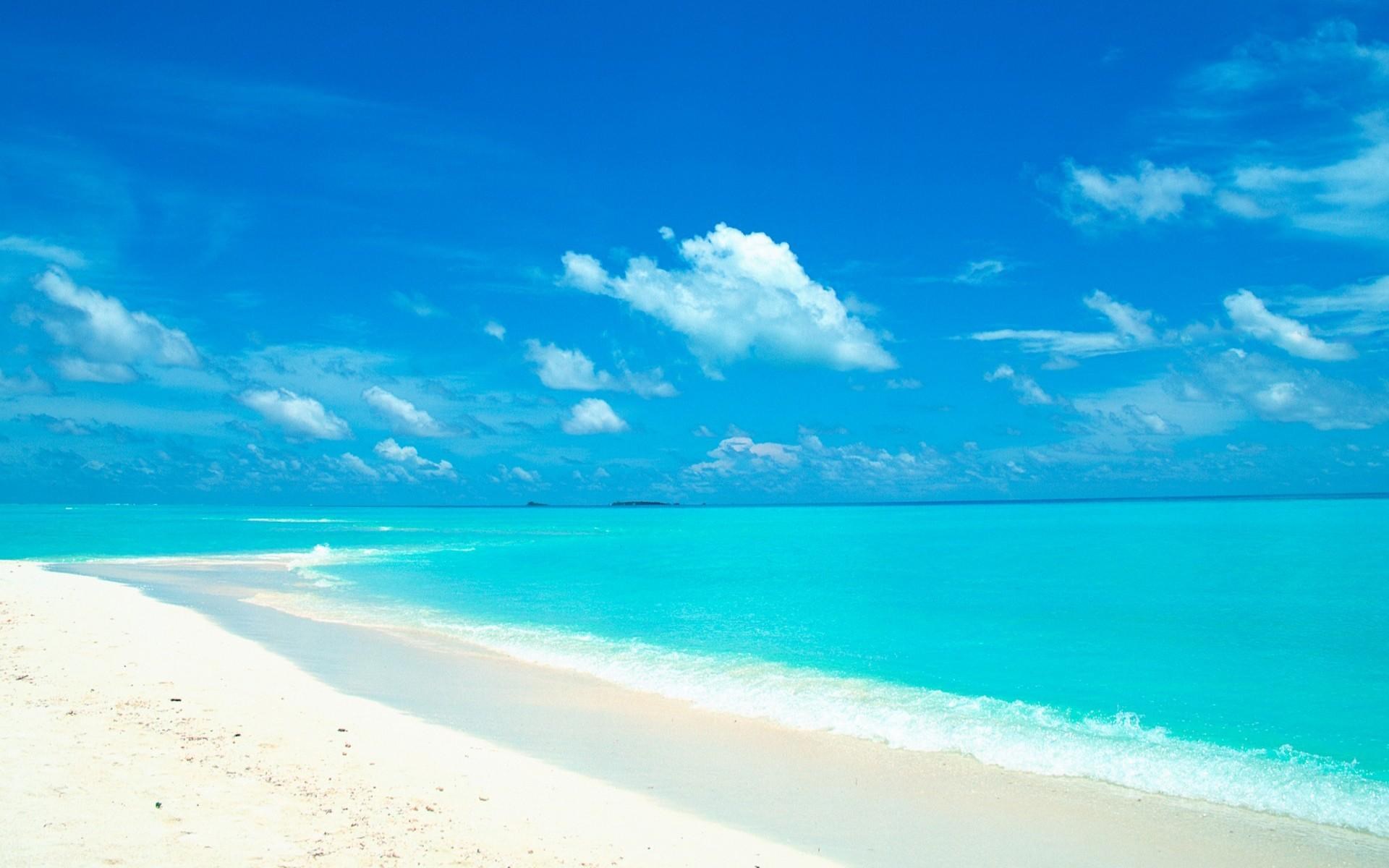 Turquoise ocean and white sand beach under blue sky with clouds HD Wallpaper