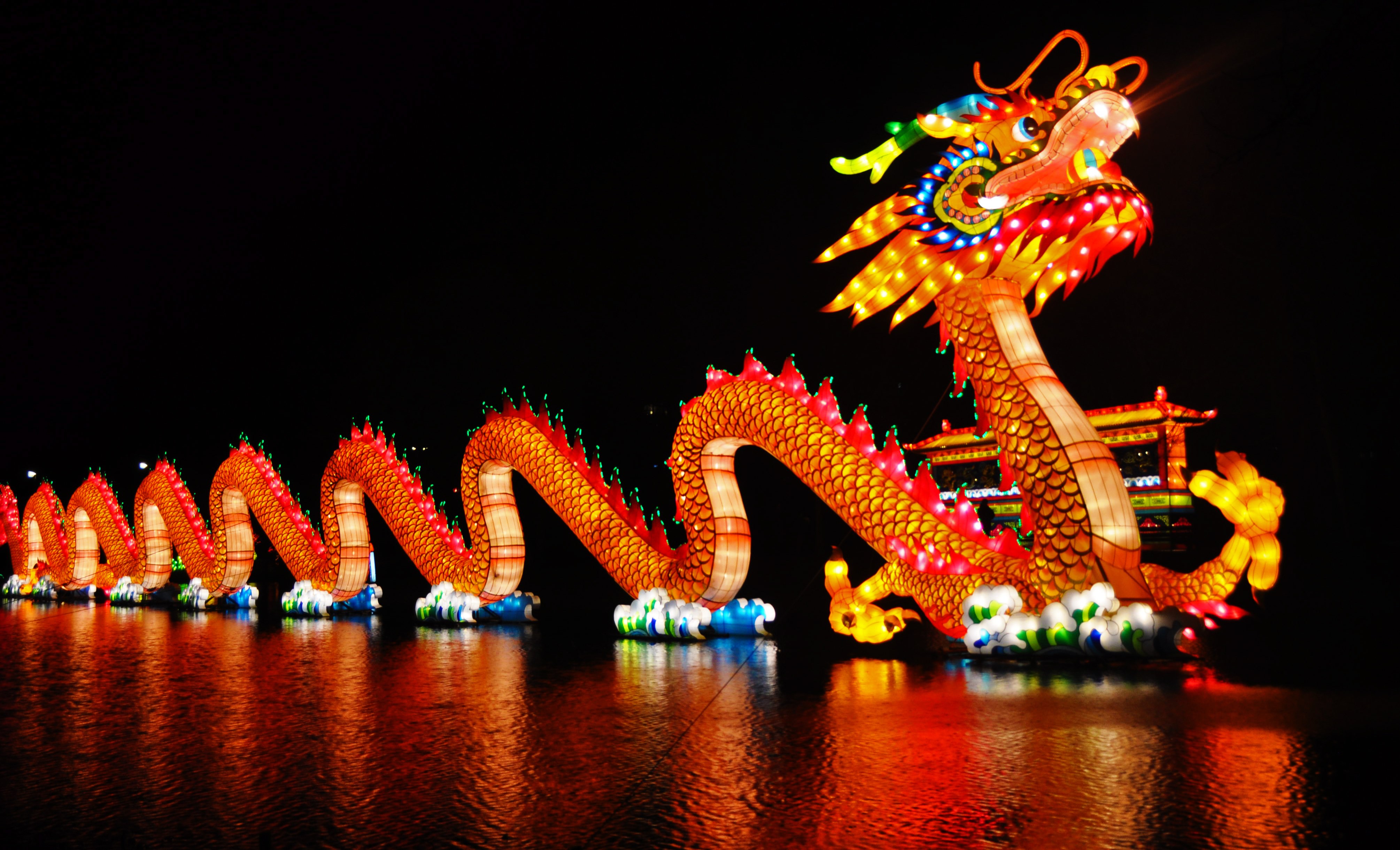 Giant illuminated dragon lantern on water HD Wallpaper