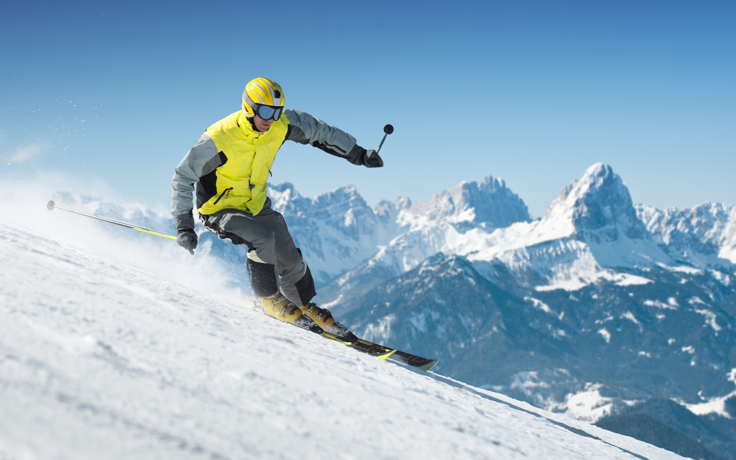 Man skiing down a snowy mountain slope HD Wallpaper