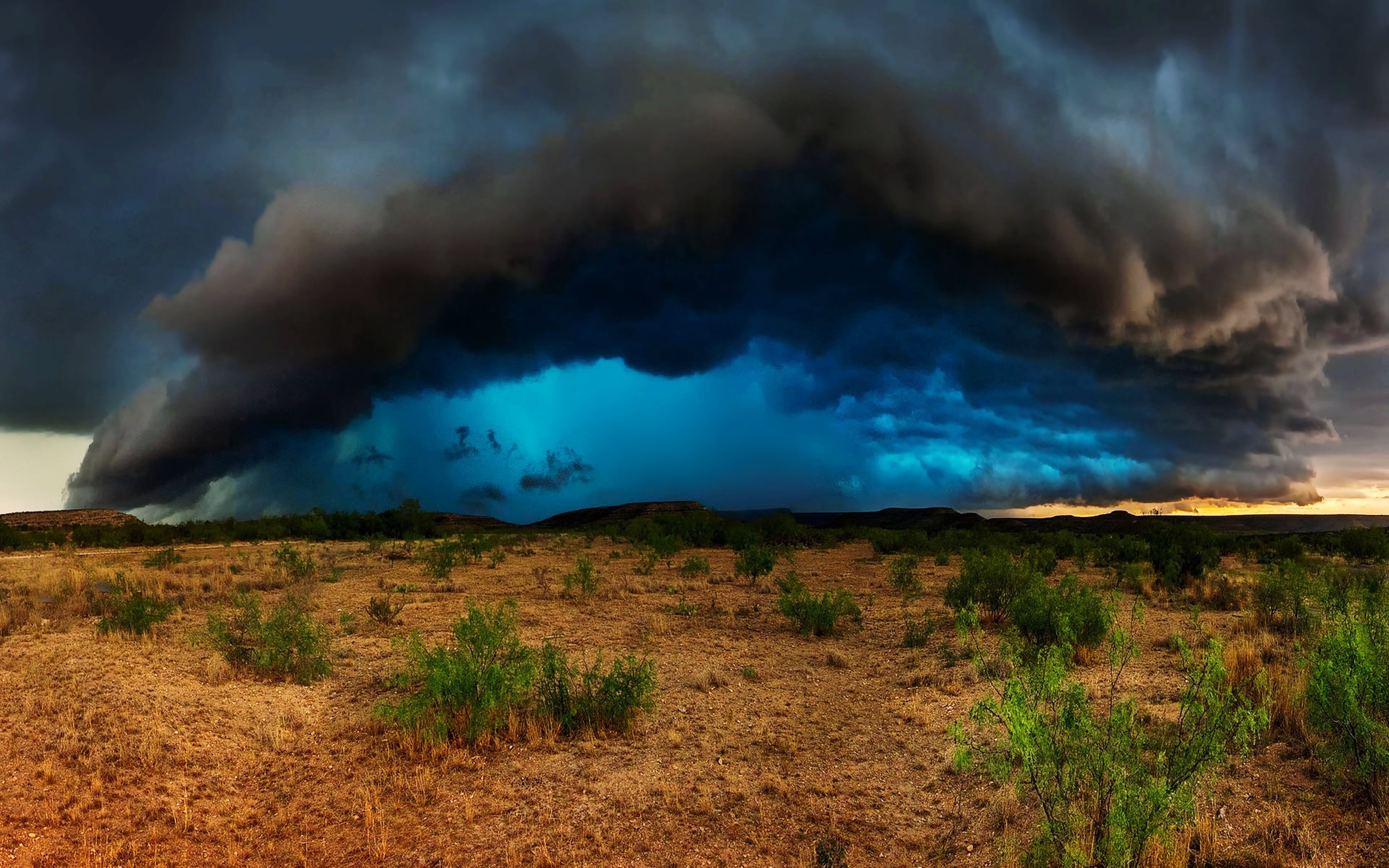 Storm clouds over a dry landscape HD Wallpaper
