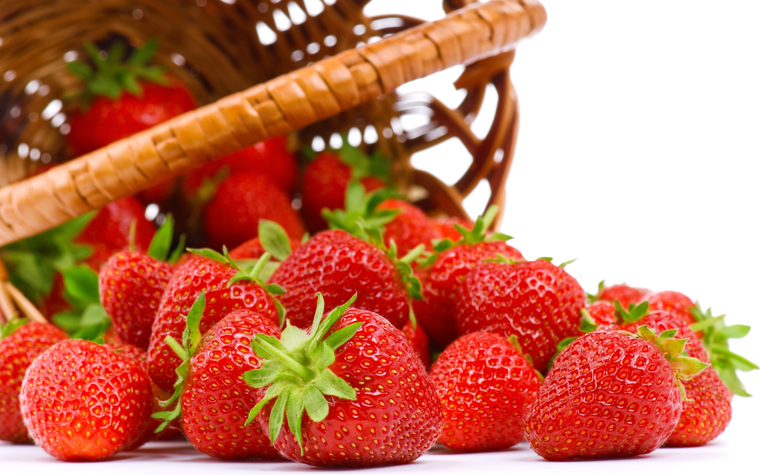 Strawberries spilling from a basket HD Wallpaper