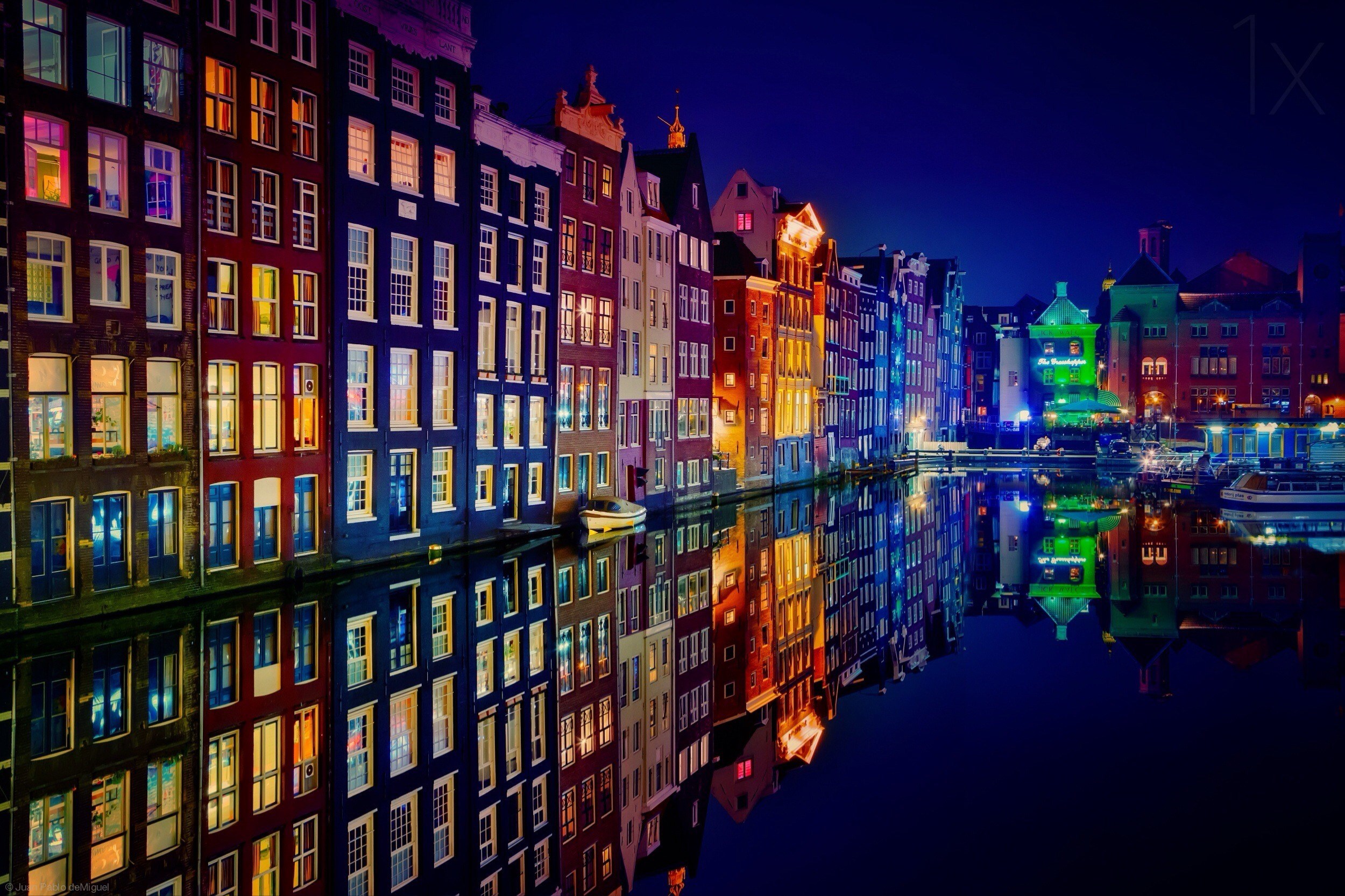 Amsterdam canal houses at night with reflections HD Wallpaper