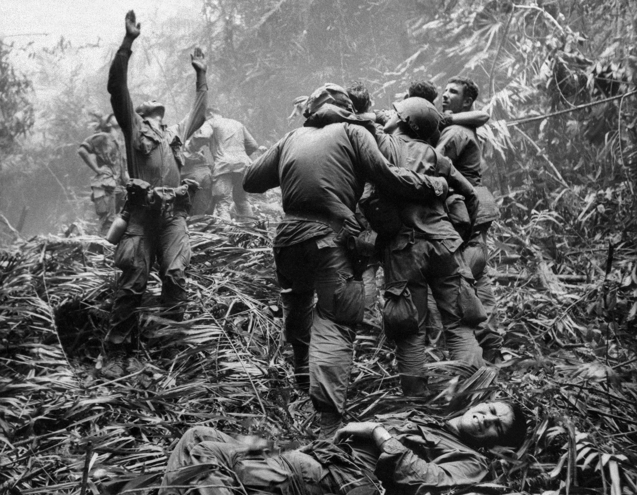 Vietnam War soldiers carrying a wounded comrade HD Wallpaper