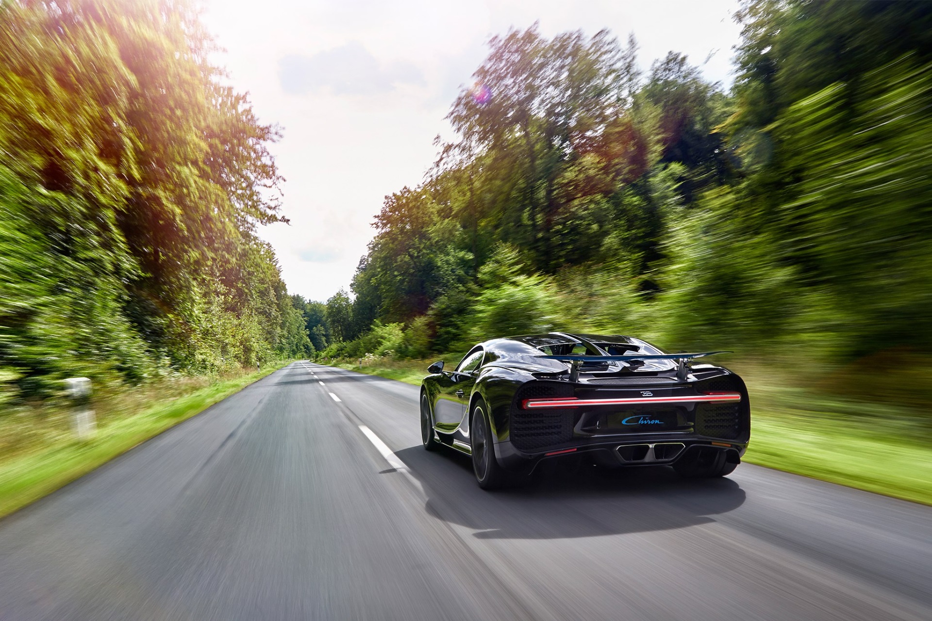 Bugatti Chiron driving on a forest road HD Wallpaper