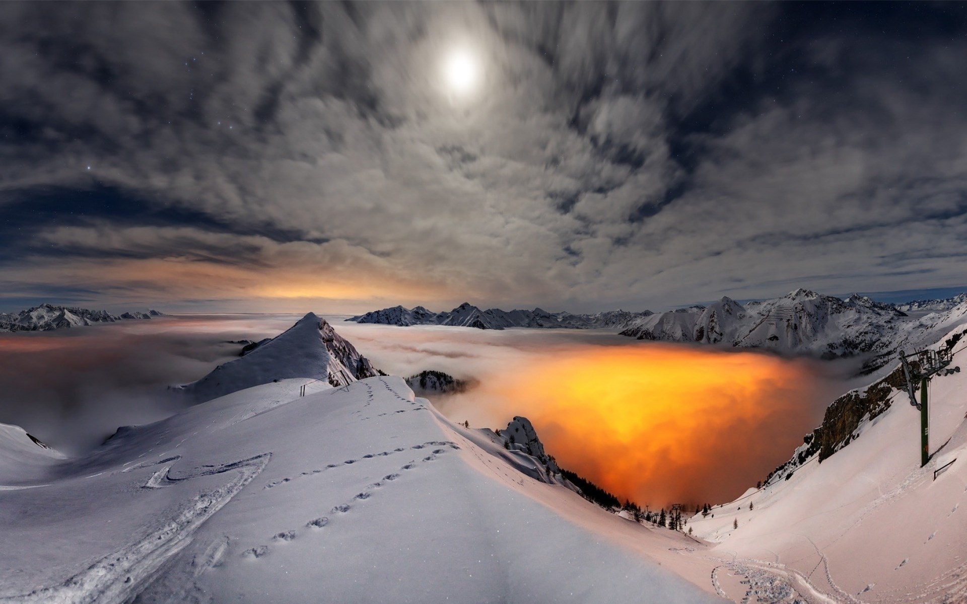 Moonlit snowy mountains above glowing clouds HD Wallpaper