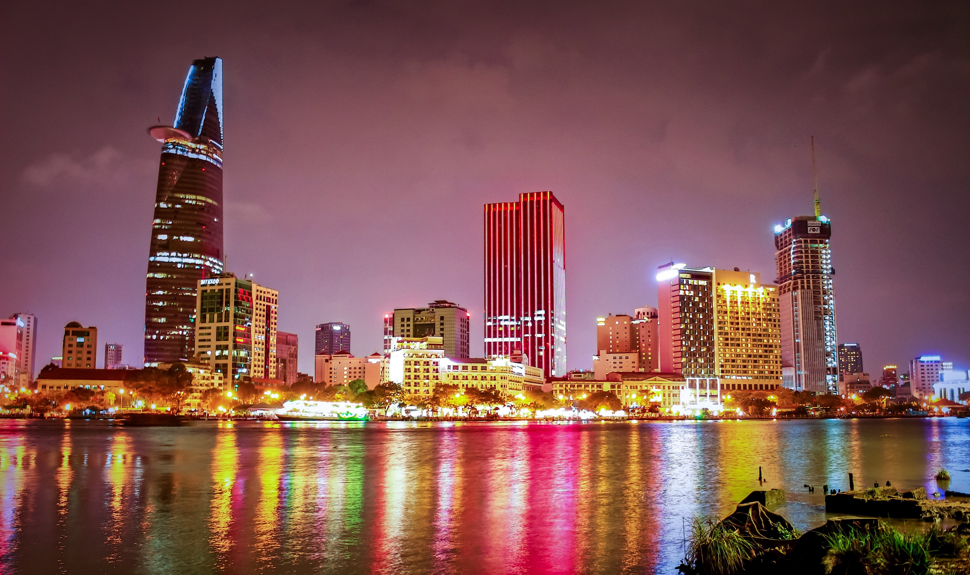 Ho Chi Minh City skyline at night with river reflection HD Wallpaper