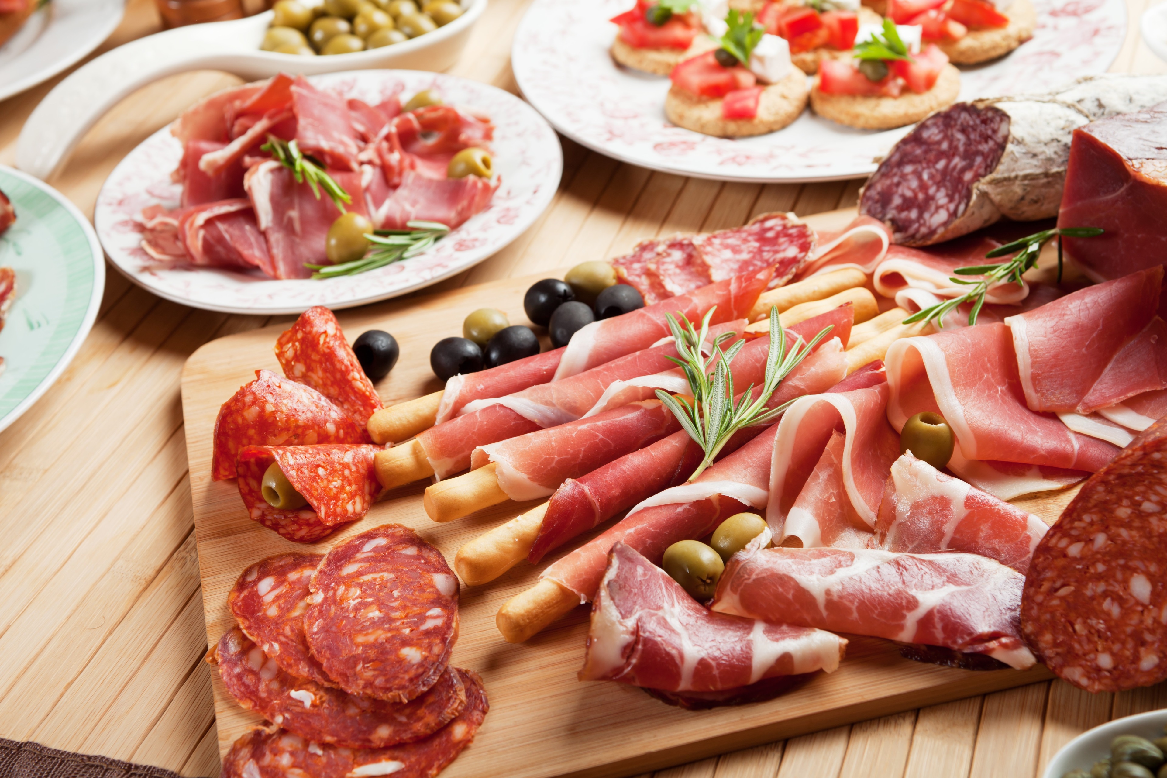4K charcuterie board with cured meats and olives HD Wallpaper